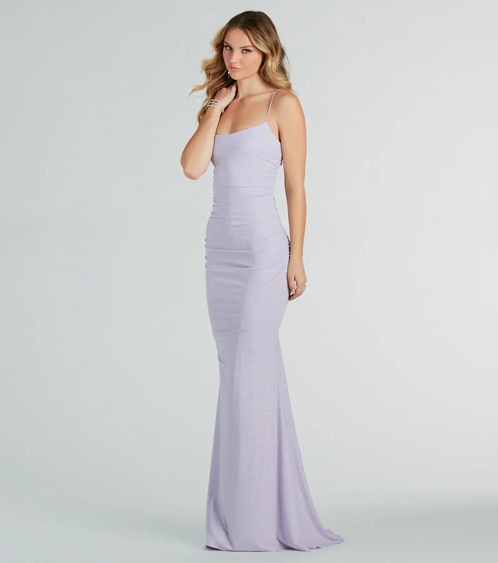 Turn heads at Prom 2025 in this lavender prom dress, where statement-making details meet the iconic style of the Rowan Formal Glitter Ruched Mermaid Dress .