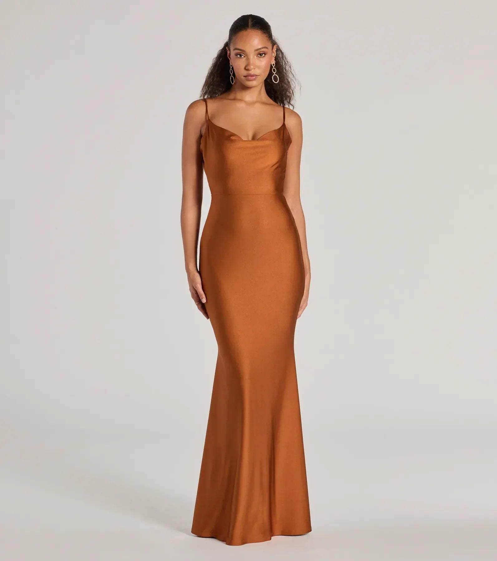 Turn heads at Prom 2025 in this copper prom dress, where statement-making details meet the iconic style of the Virginia Cowl Neck Tie-Back Mermaid Formal Dress .
