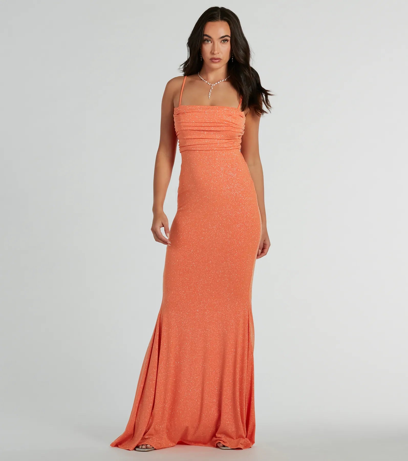 Turn heads at HOCO 2025 in this orange homecoming dress, where statement-making details meet the iconic style of the Colleen Lace Up Mermaid Glitter Formal Dress.