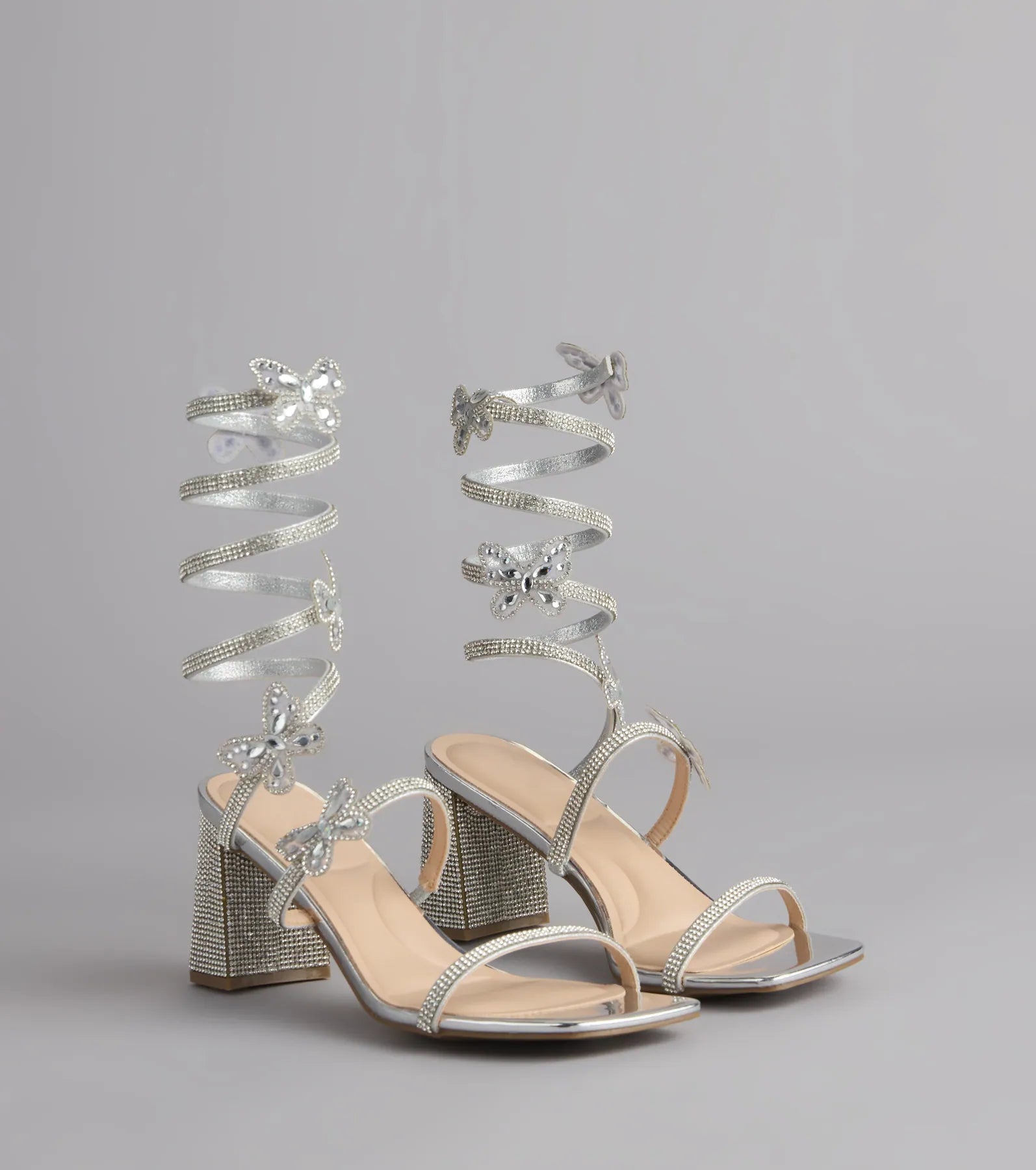 Style made simple with the Flutter Up Rhinestone Spiral Strap Heels in silver, trendy women’s shoes that take your outfit from basic to bold in one step.