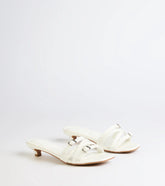 Style made simple with the Trendy Steps Buckle Strap Kitten Heel Mules in white, trendy women’s shoes that take your outfit from basic to bold in one step.