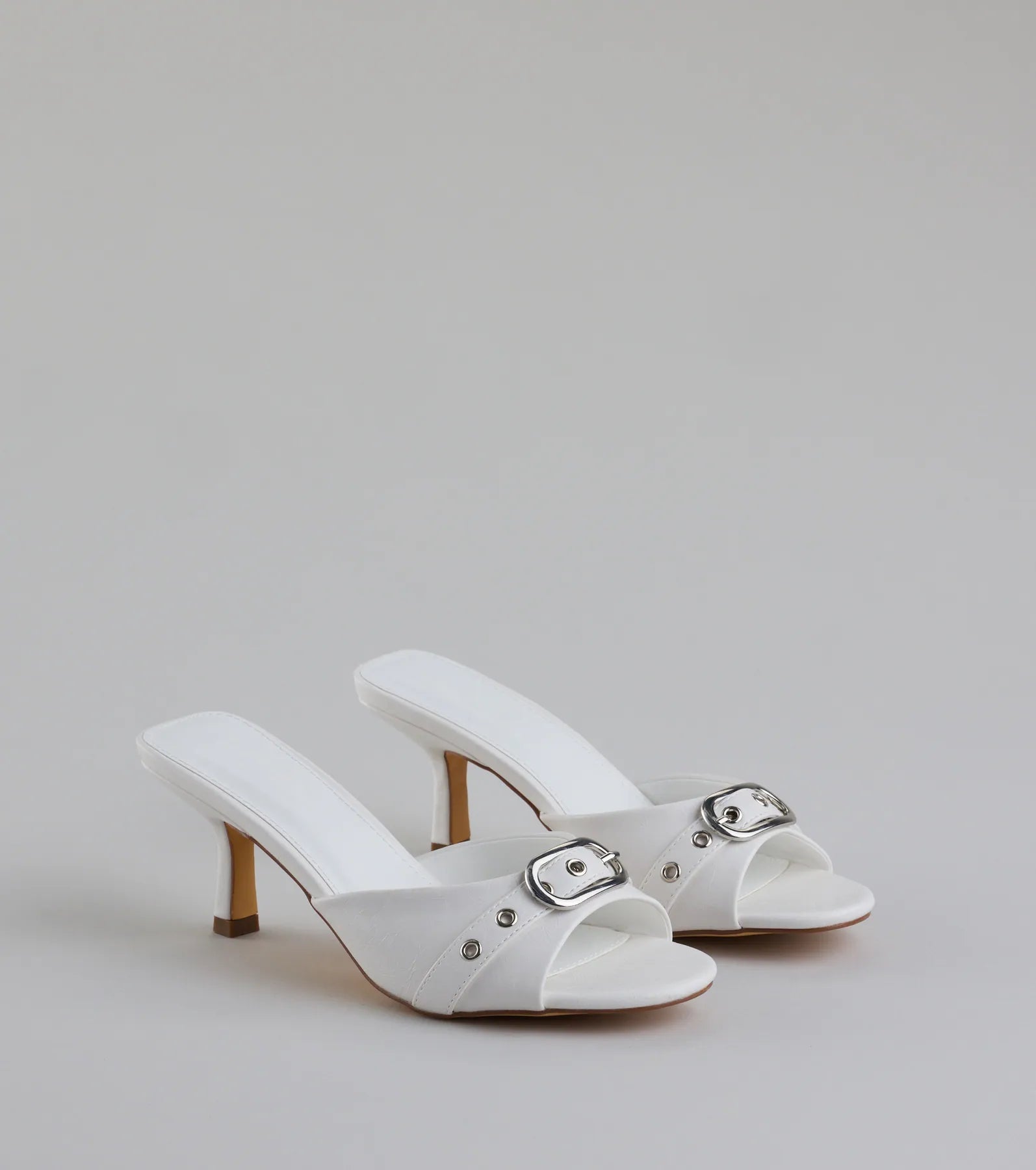 Style made simple with the Brunch To Cocktails Buckle Stiletto Mules in white, trendy women’s shoes that take your outfit from basic to bold in one step.