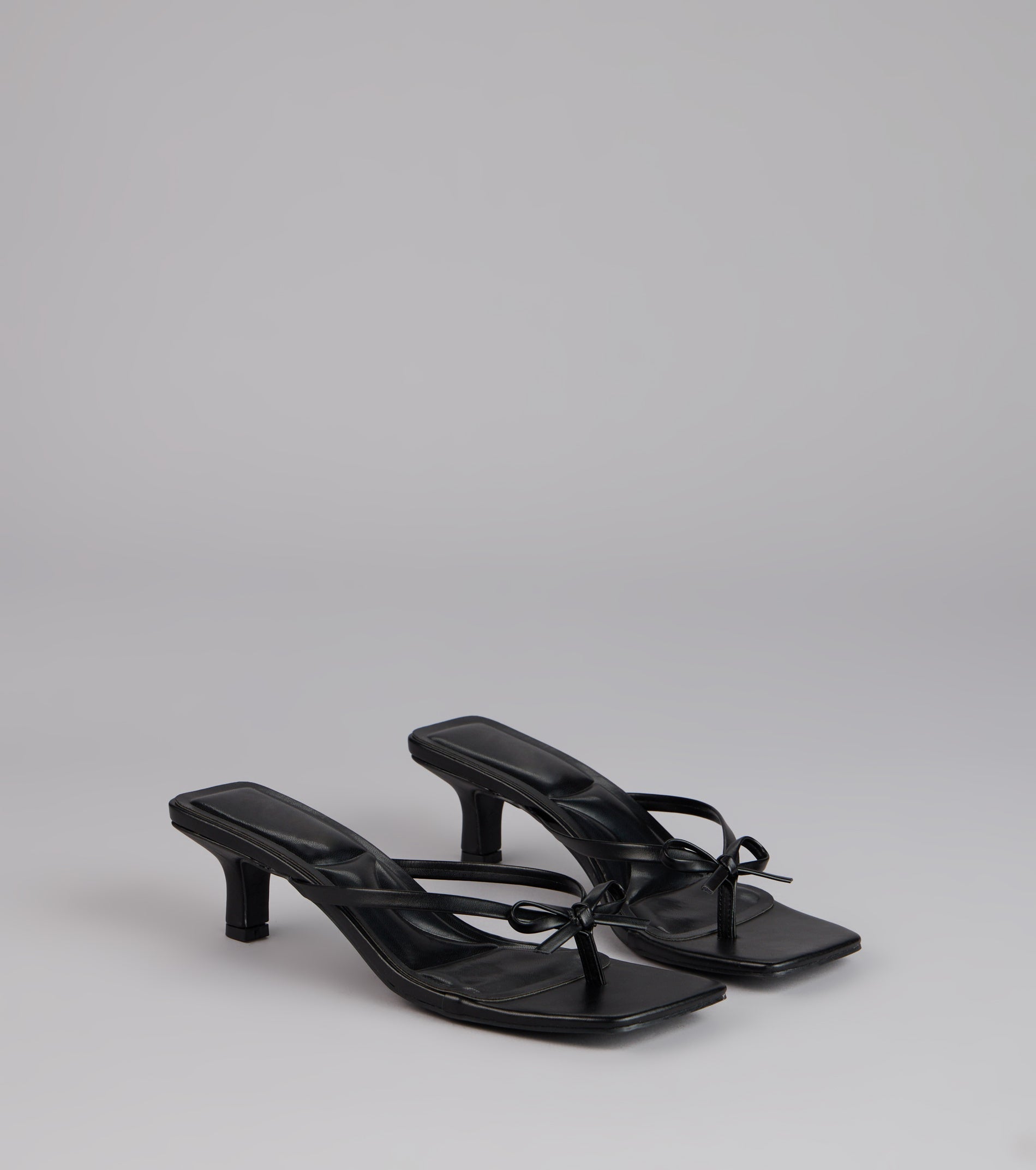 Style made simple with the Play Nice Bow Thong Heels, trendy women’s shoes that take your outfit from basic to bold in one step.