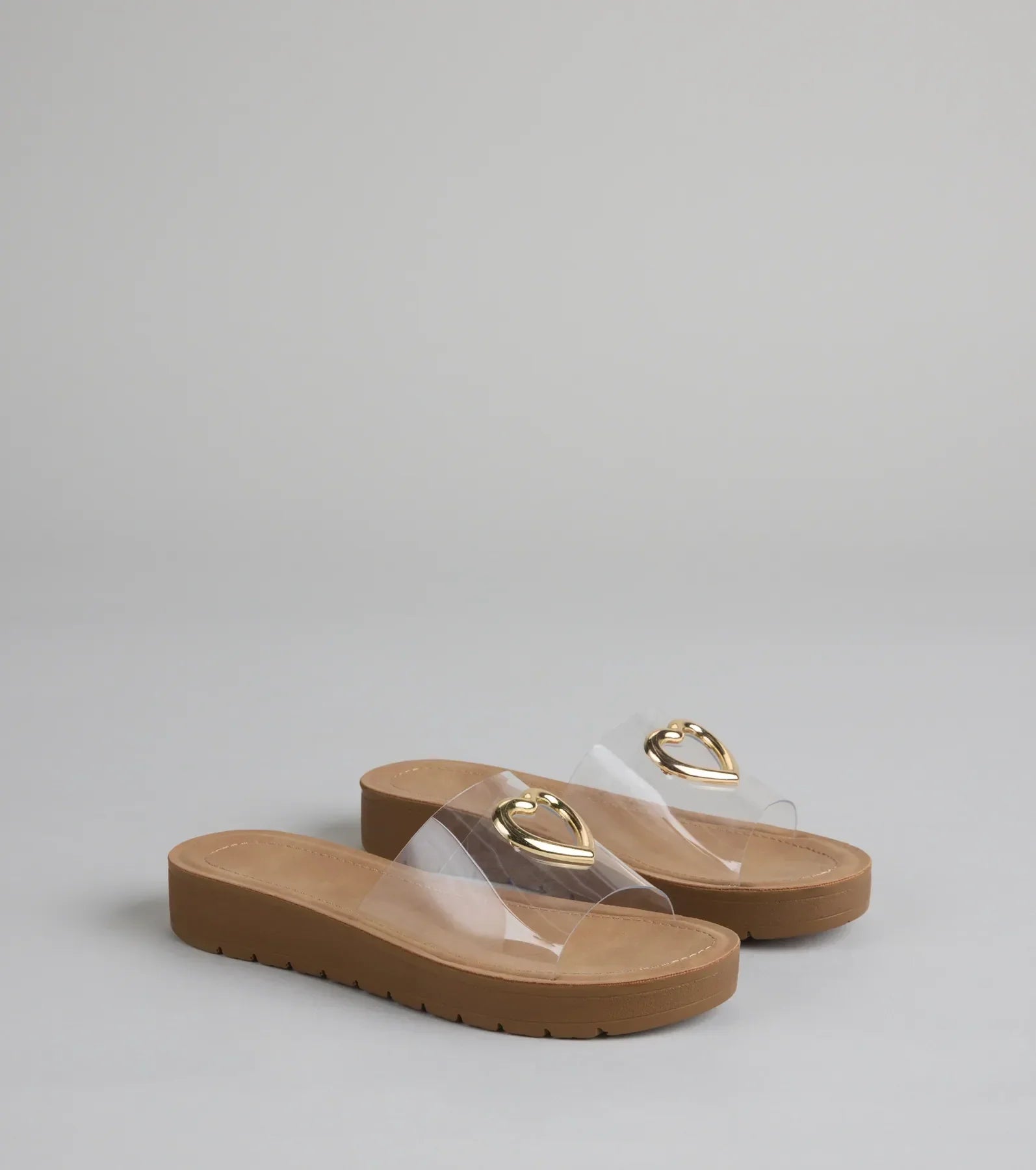 Style made simple with the Heart Eyes Only Slide Sandals in clear, trendy women’s shoes that take your outfit from basic to bold in one step.