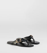 Style made simple with the Statement Gleam Buckle Thong Sandals in black, trendy women’s shoes that take your outfit from basic to bold in one step.