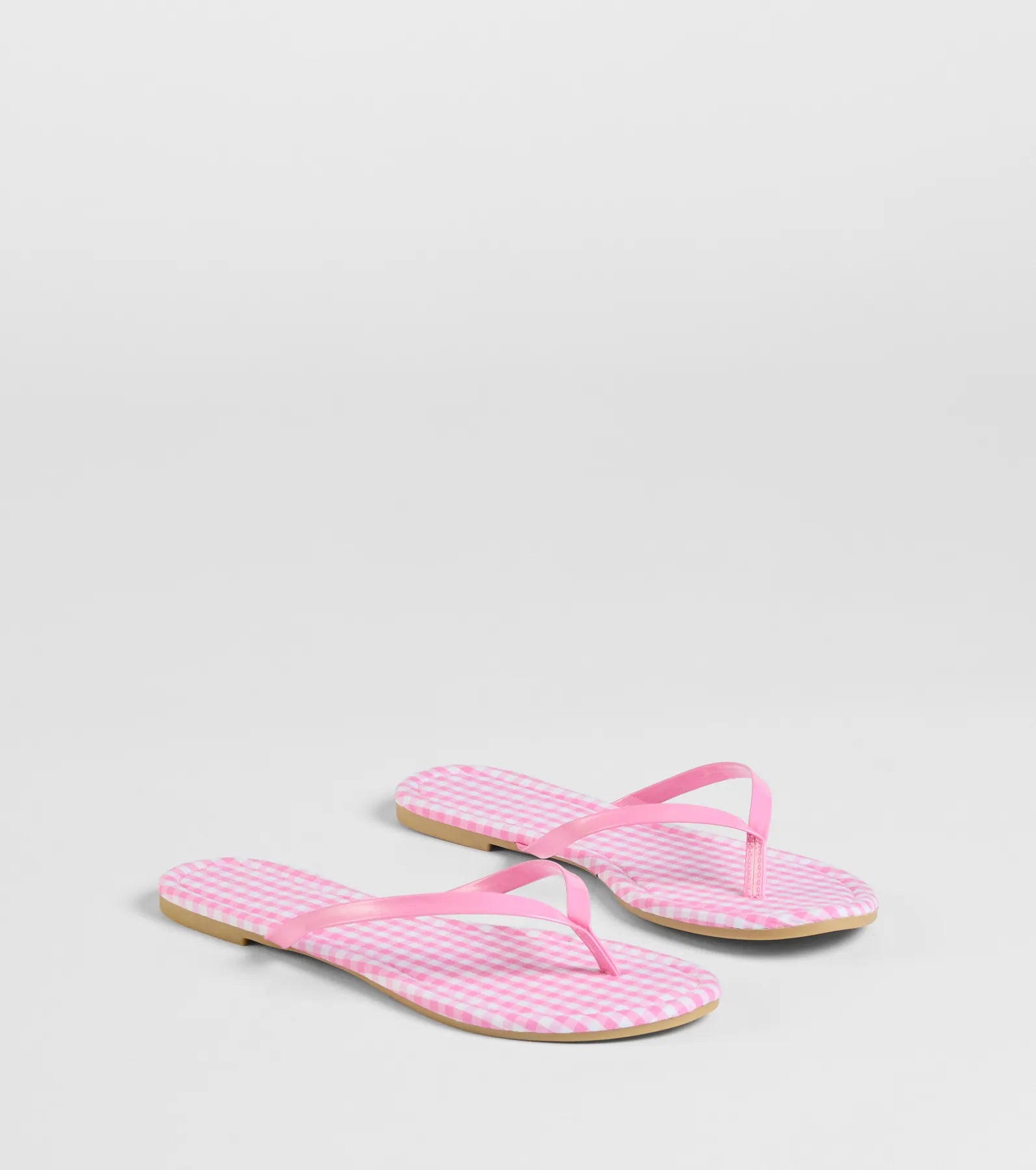 Style made simple with the Cutie Vibe Gingham Print Thong Strap Sandals in pink, trendy women’s shoes that take your outfit from basic to bold in one step.