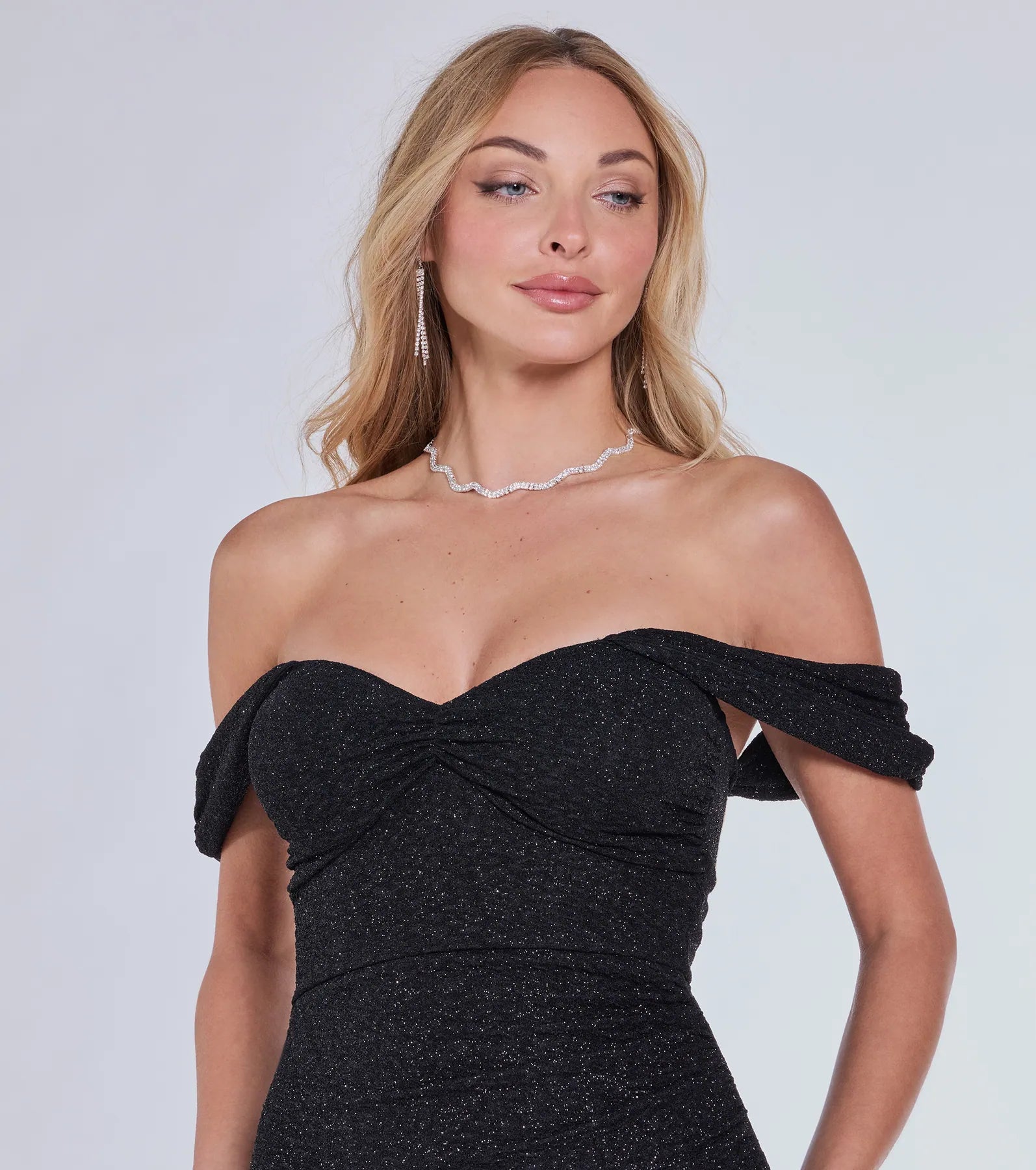 Own the spotlight in the Lennon Glitter Knit Off-The-Shoulder Midi Dress, a black formal dress crafted to deliver luxe style for winter weddings, Military Balls, or any special event.