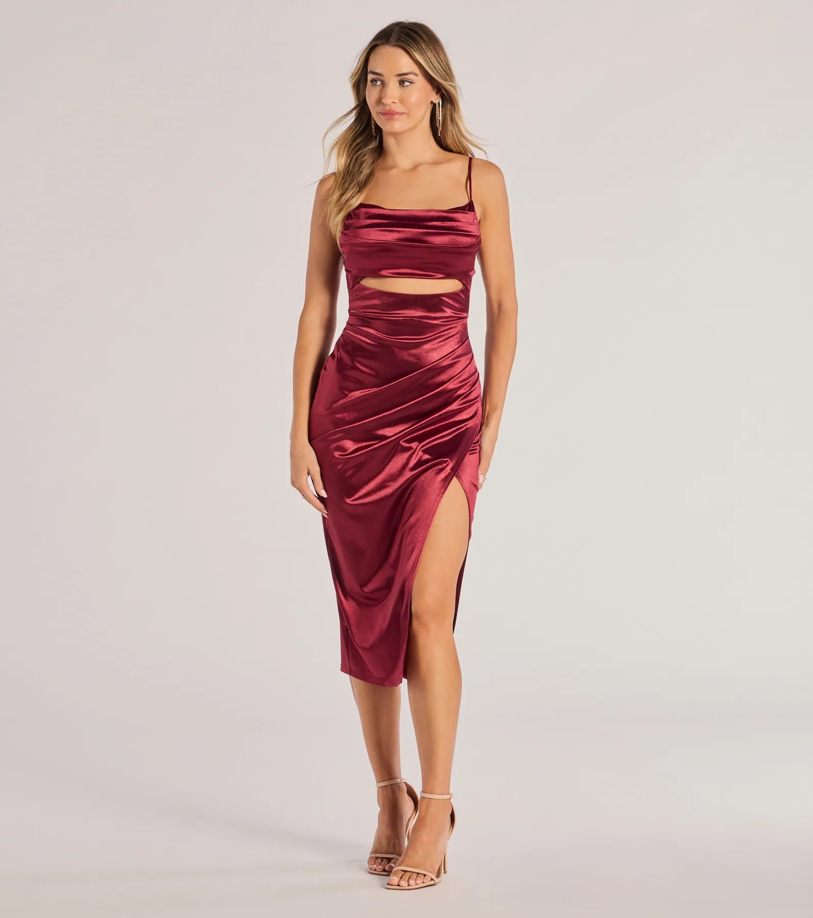 The Lilith Satin Cutout Wrap-Front Midi Dress in wine is a modern red dress featuring trendy details and a stunning design ideal for wedding guest dresses, elegant cocktail looks, or an alluring birthday dress.