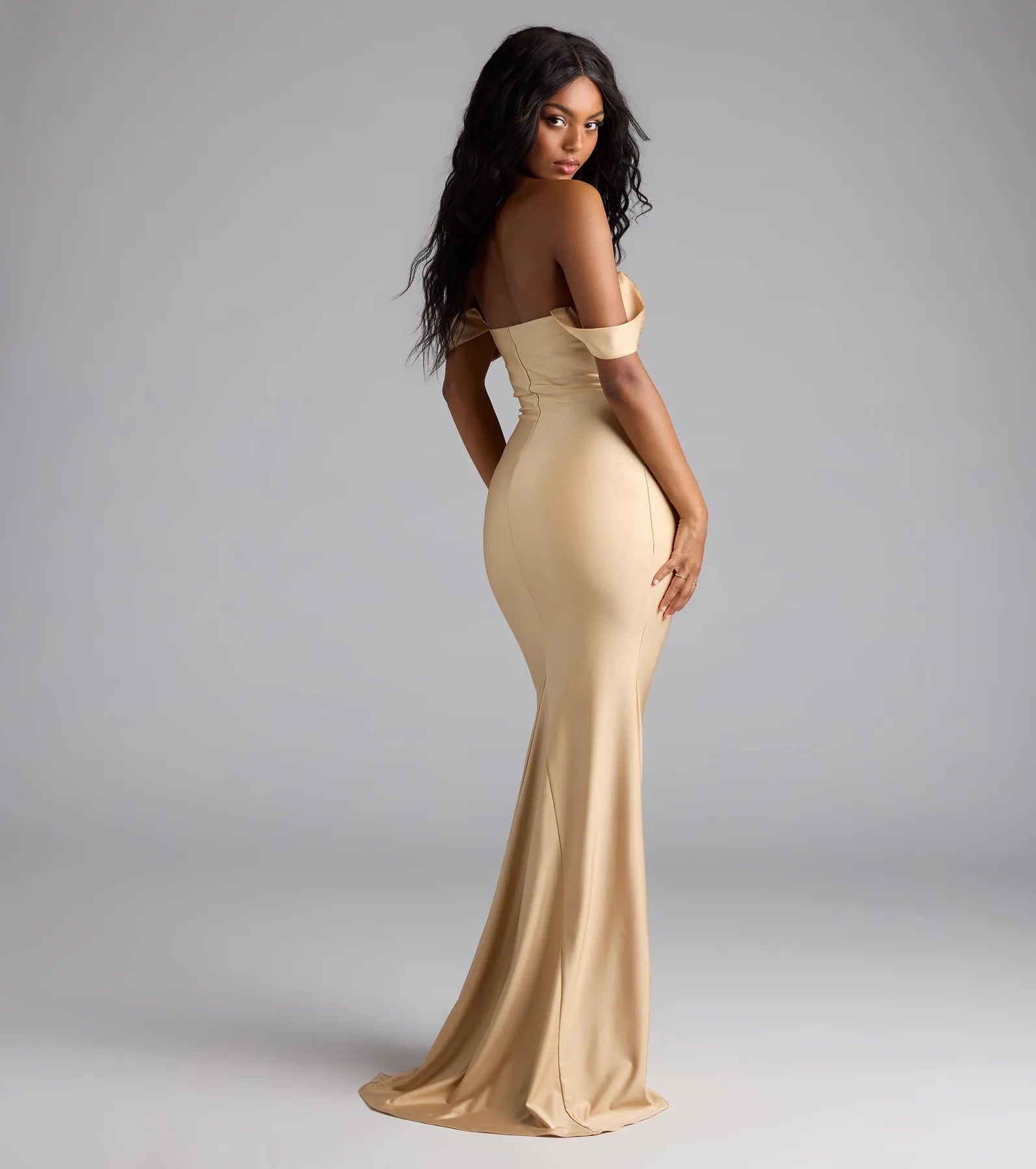 Own the spotlight in the Maylah Off-The-Shoulder Mermaid Dress, a gold formal dress crafted to deliver luxe style for fall weddings, Army Balls, or any special event.