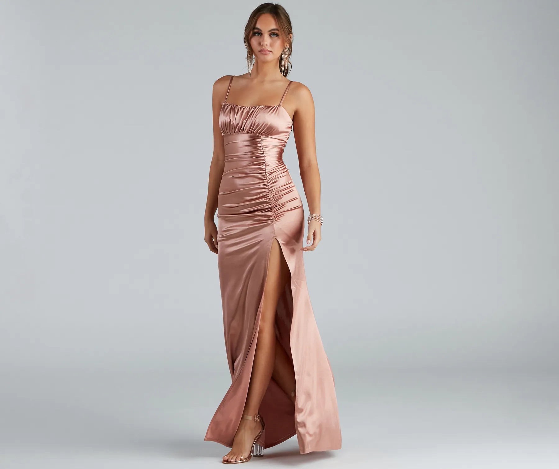 Turn heads at Prom 2025 in this copper prom dress, where statement-making details meet the iconic style of the Brooklyn Satin Ruched Formal Dress .