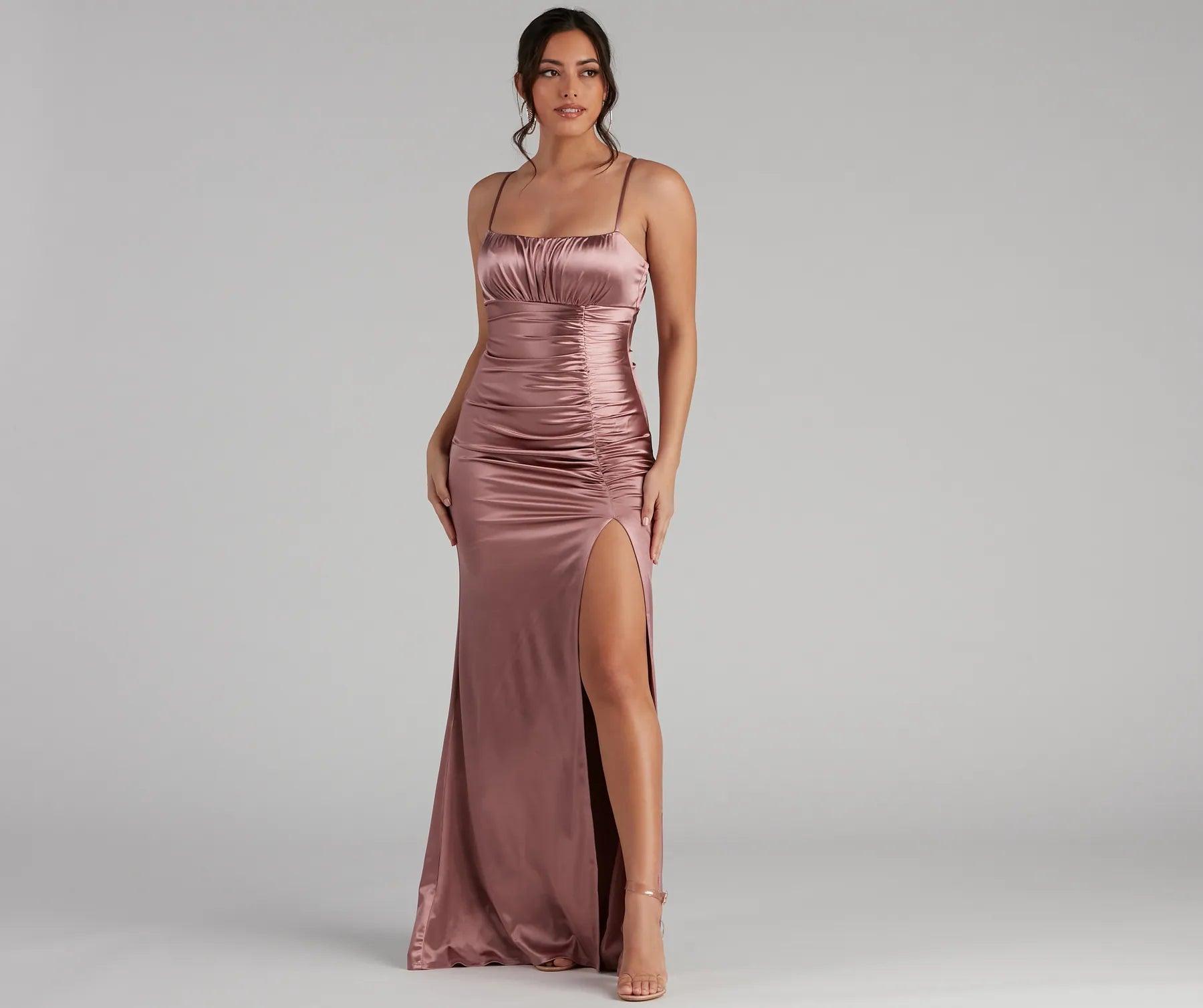 Turn heads at Prom 2025 in this mauve prom dress, where statement-making details meet the iconic style of the Brooklyn Satin Ruched Formal Dress .