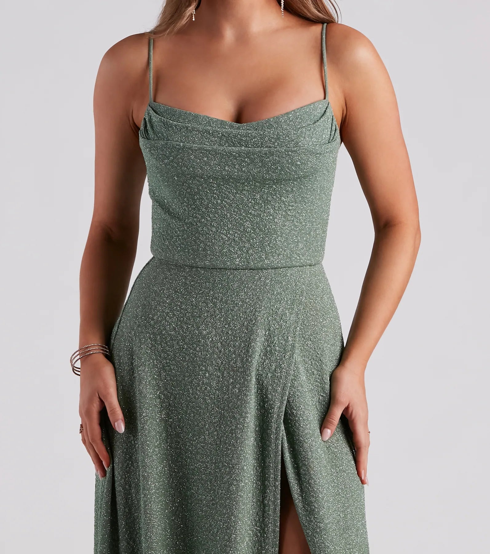 The Stephanie Formal Glitter A-Line Dress in sage is a stunning green prom dress designed to capture attention with its fresh or bold color and effortlessly stylish silhouette.