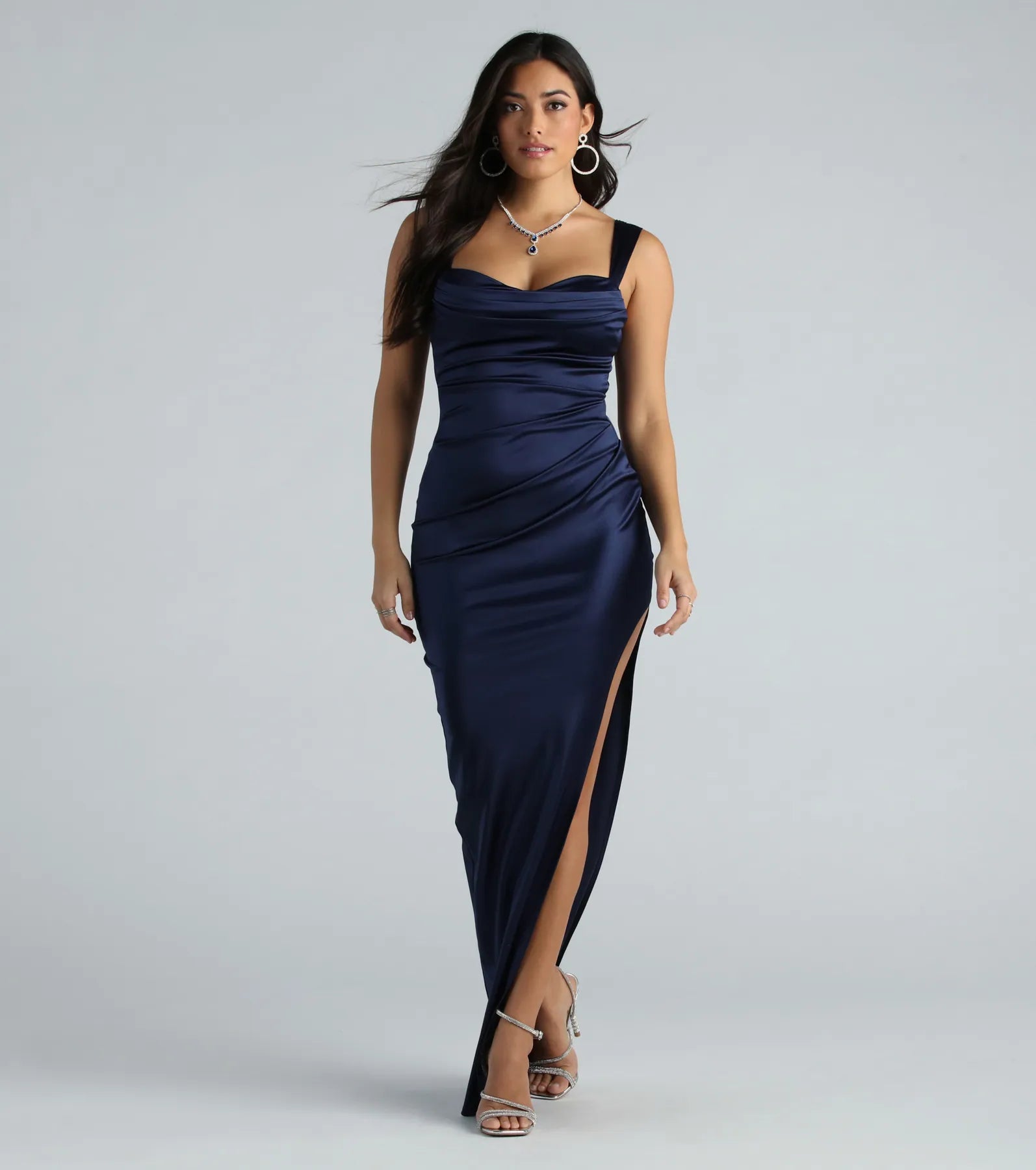 Turn heads at HOCO 2025 in this navy blue homecoming dress, where statement-making details meet the iconic style of the Kirsten Satin Cowl Neck High Slit Formal Dress.