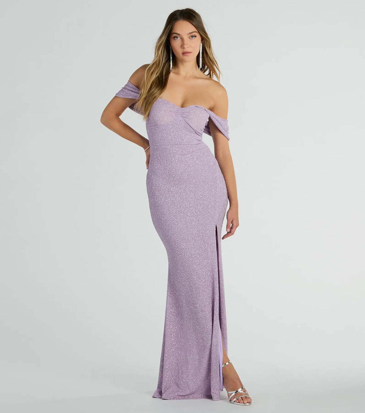 Turn heads at Prom 2025 in this lavender prom dress, where statement-making details meet the iconic style of the Tamara Off-The-Shoulder Mermaid Glitter Formal Dress .