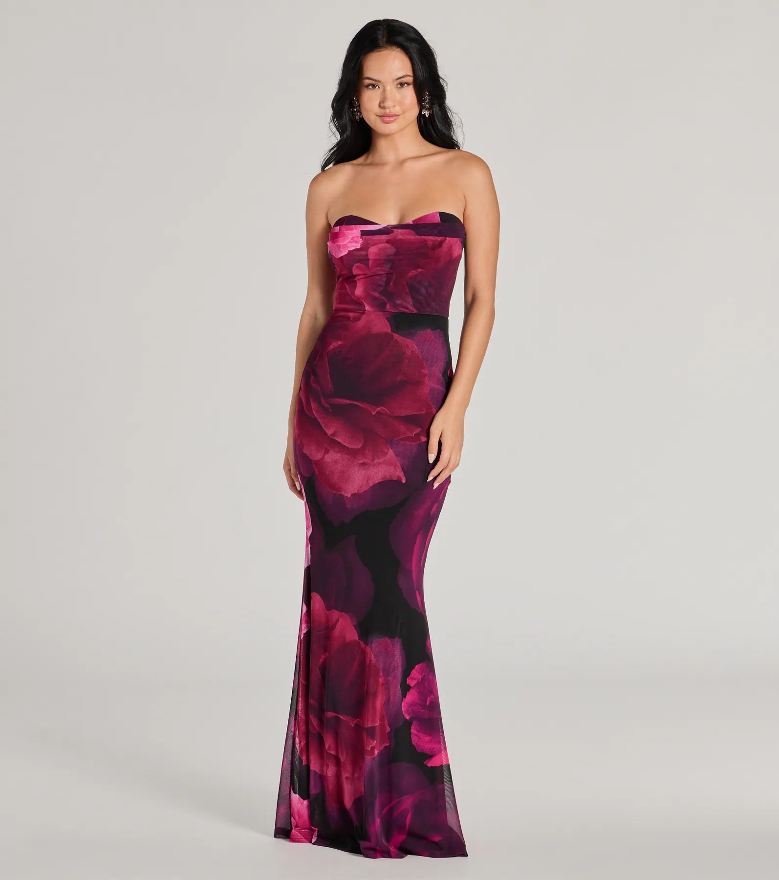 Turn heads at Prom 2025 in this magenta prom dress, where statement-making details meet the iconic style of the Julianna Floral Mesh Strapless Mermaid Dress .