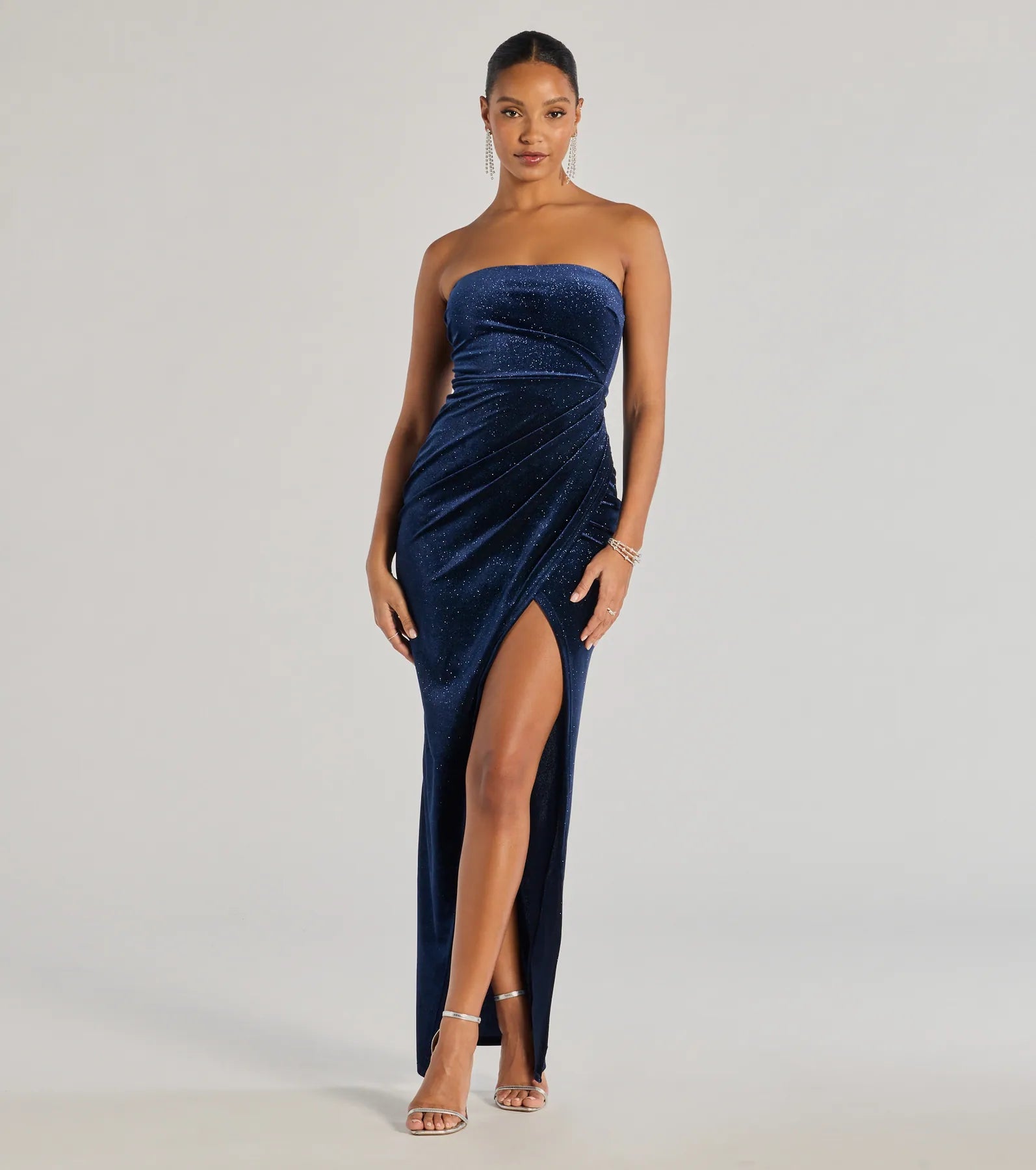 Turn heads at Prom 2025 in this navy blue prom dress, where statement-making details meet the iconic style of the Cordelia Velvet Glitter Long Wrap Dress .
