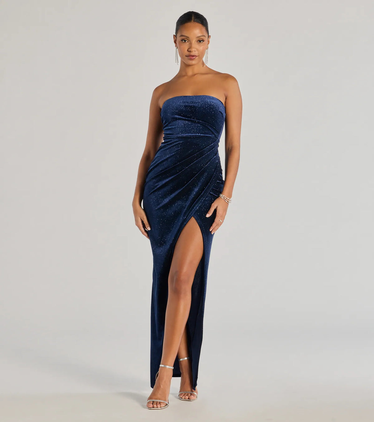 Turn heads at Prom 2025 in this navy blue prom dress, where statement-making details meet the iconic style of the Cordelia Velvet Glitter Long Wrap Dress .