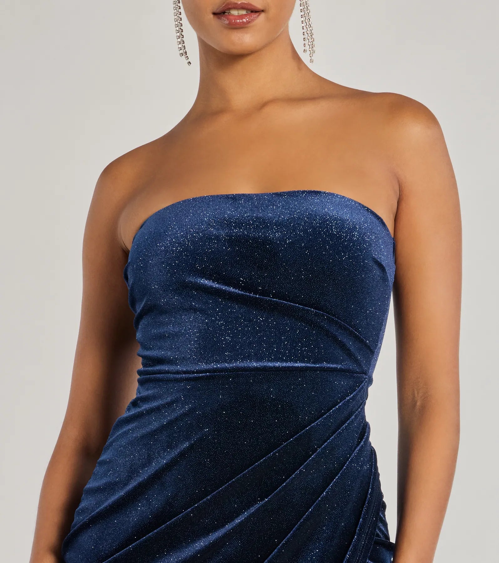 Own the spotlight in the Cordelia Velvet Glitter Long Wrap Dress, a navy blue formal dress crafted to deliver luxe style for autumn weddings, Military Balls, or any special event.
