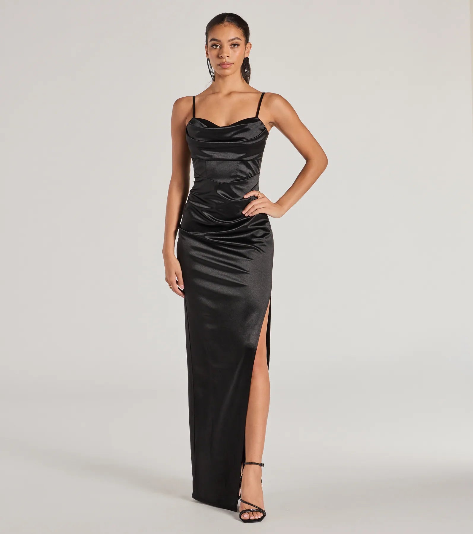 Turn heads at HOCO 2025 in this black homecoming dress, where statement-making details meet the iconic style of the Iliana Cowl Neck High Slit Satin Formal Dress.