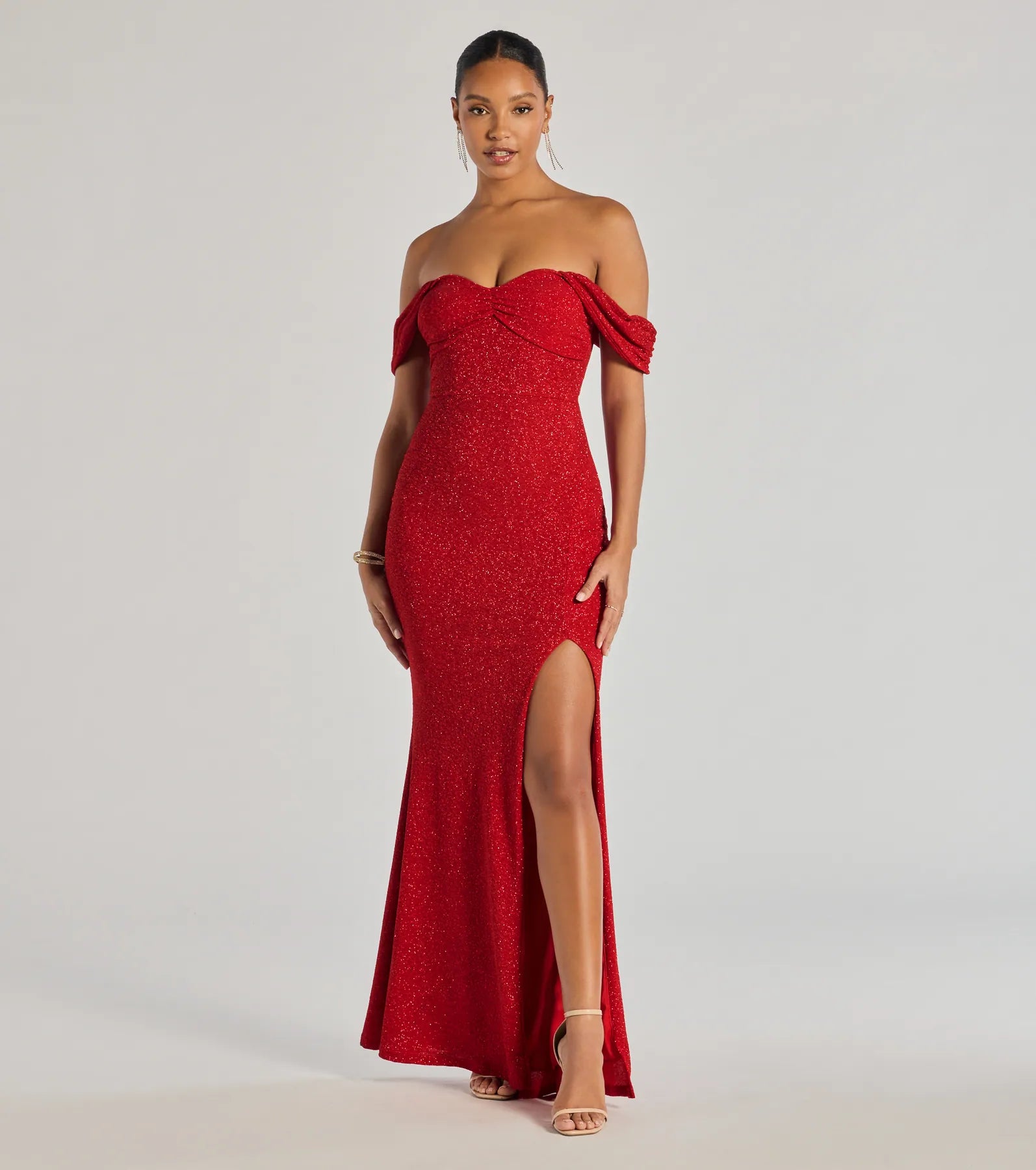Turn heads at Prom 2025 in this red prom dress, where statement-making details meet the iconic style of the Tamara Off-The-Shoulder Mermaid Glitter Formal Dress .