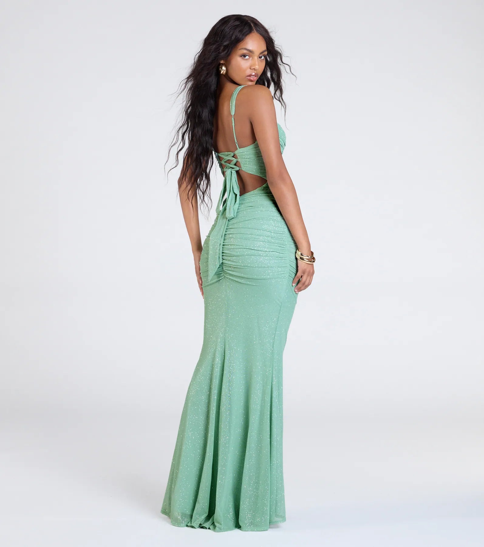 The Jenna Lace-Up Ruched Mermaid Glitter Formal Dress in sage is a stunning green prom dress designed to capture attention with its fresh or bold color and effortlessly stylish silhouette.