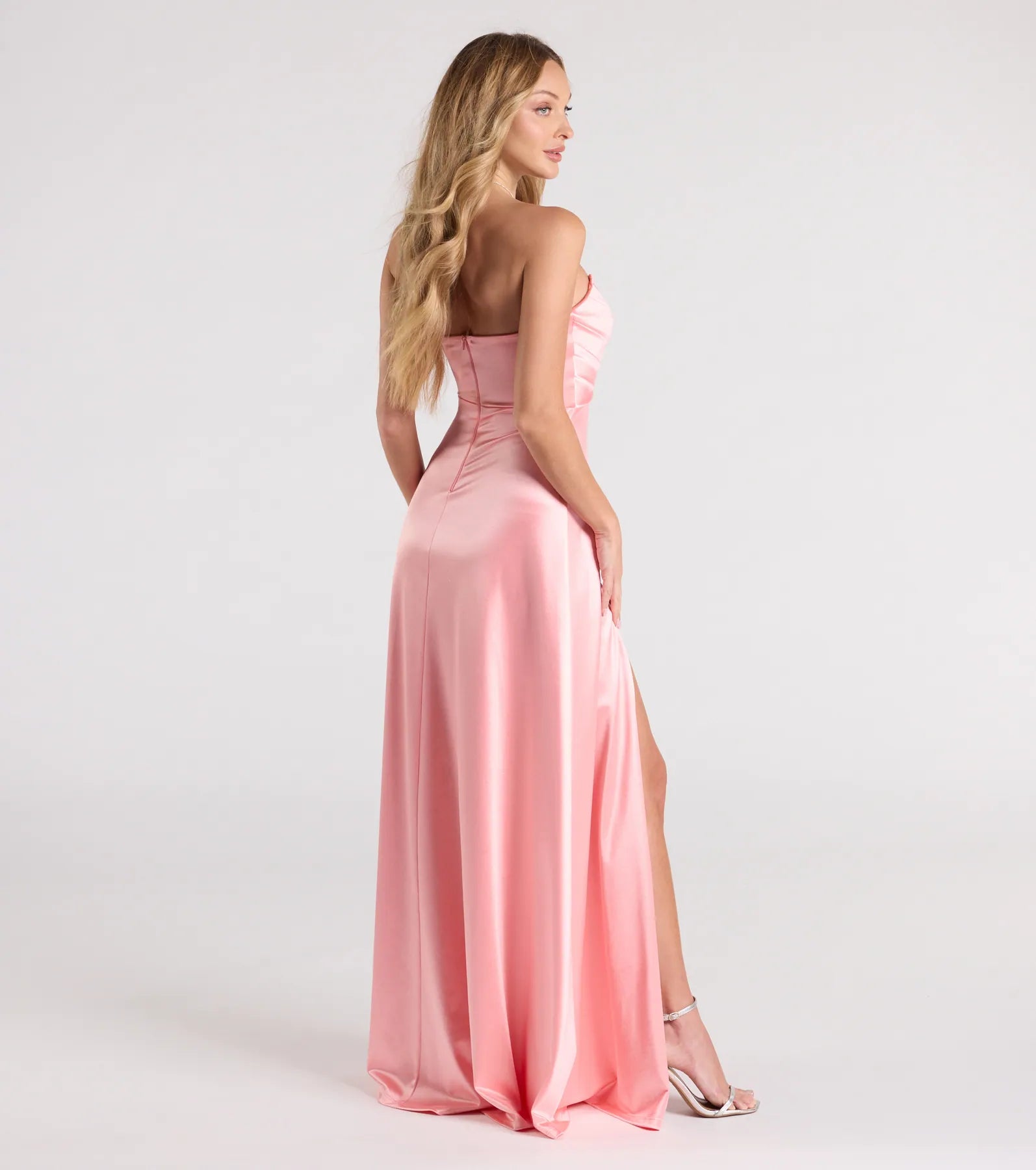 Turn heads at Prom 2025 in this coral prom dress, where statement-making details meet the iconic style of the Alison Strapless Slit A-Line Satin Formal Dress.