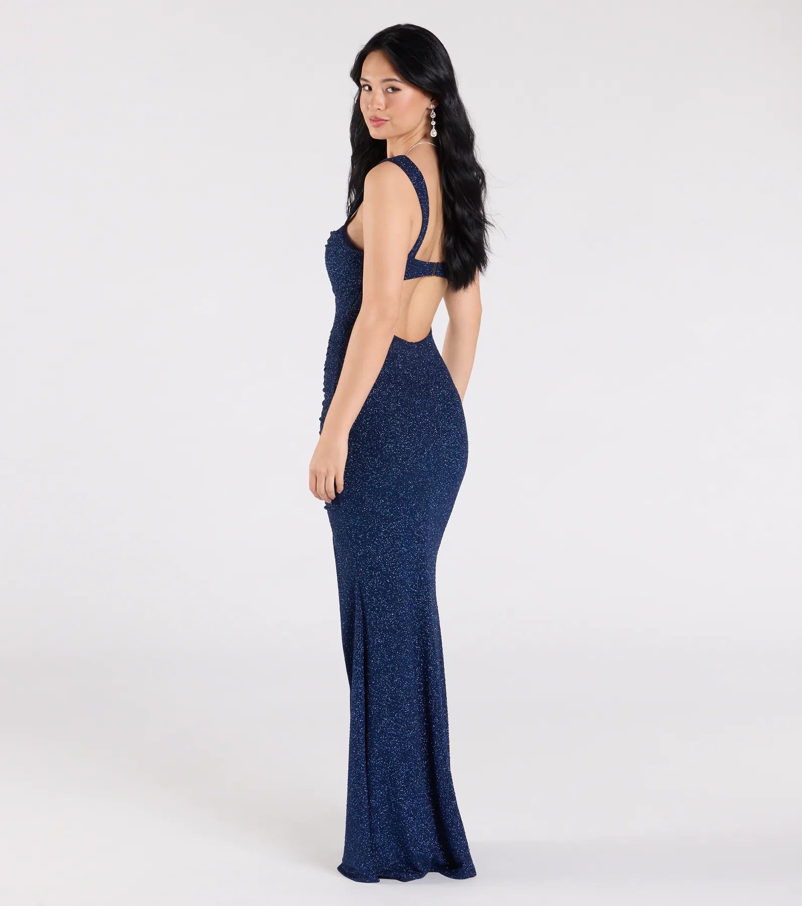 Step into the Prom 2025 dance in the Drew Open Back Glitter Mermaid Dress in navy, a stunning blue prom dress designed to complement any theme with its timeless allure and statement-making style.
