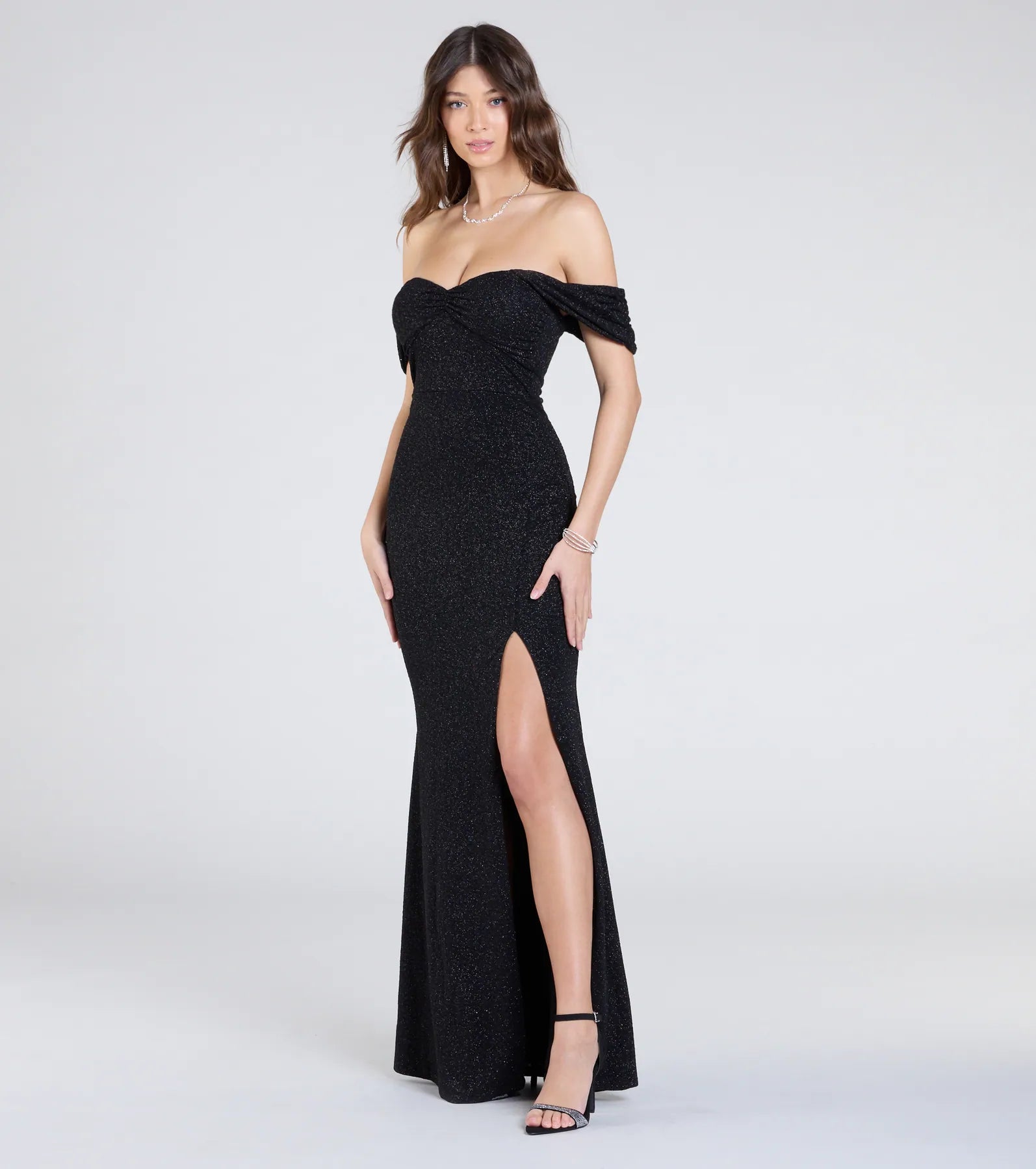 The Tamara Off-The-Shoulder Mermaid Glitter Formal Dress is a show-stopping black prom dress, offering a sleek, slimming silhouette that enhances your natural beauty for an unforgettable night.