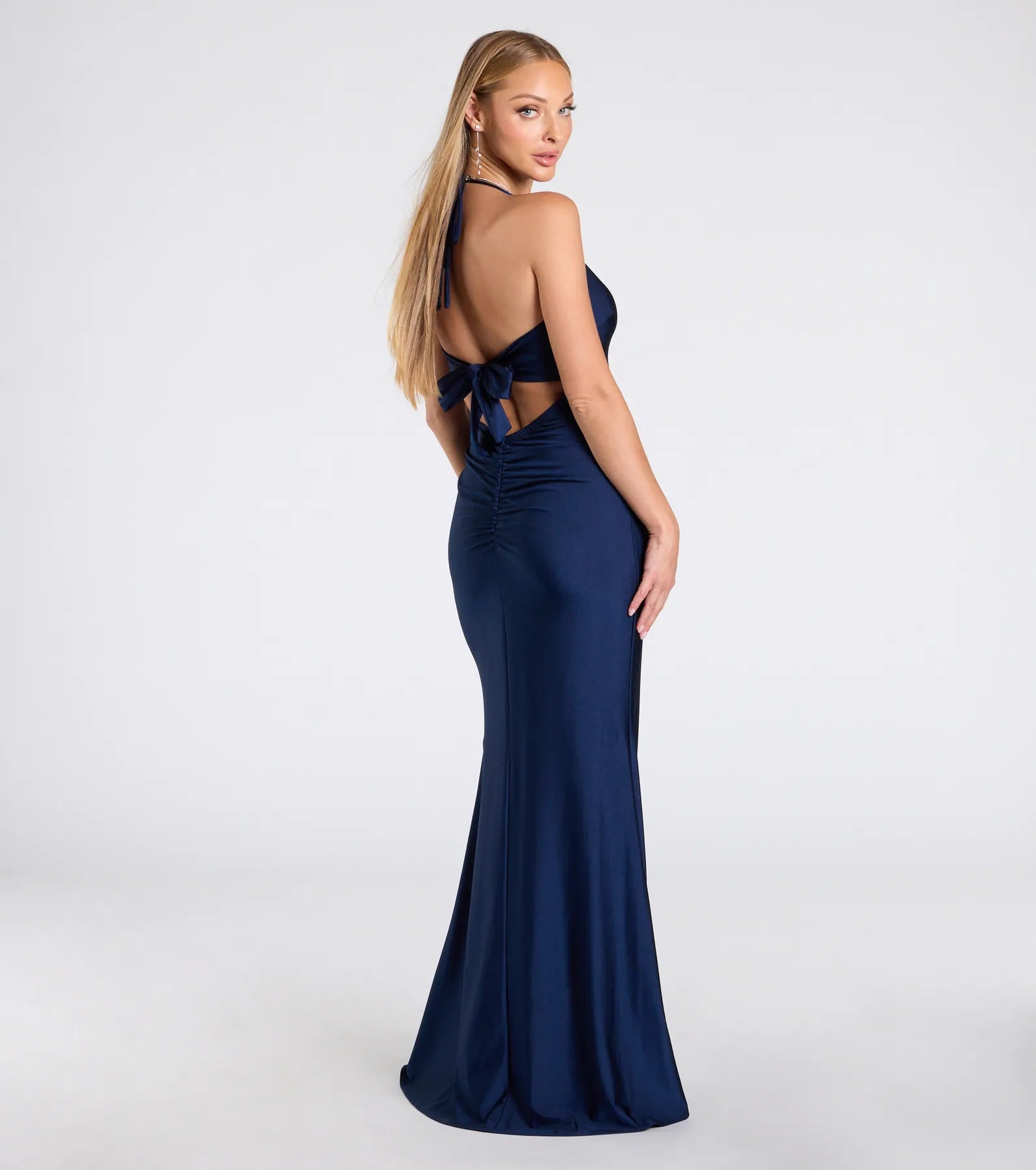 Step into the Prom 2025 dance in the Becky V-Neck Tie-Back Slit Mermaid Dress in navy, a stunning blue prom dress designed to complement any theme with its timeless allure and statement-making style.