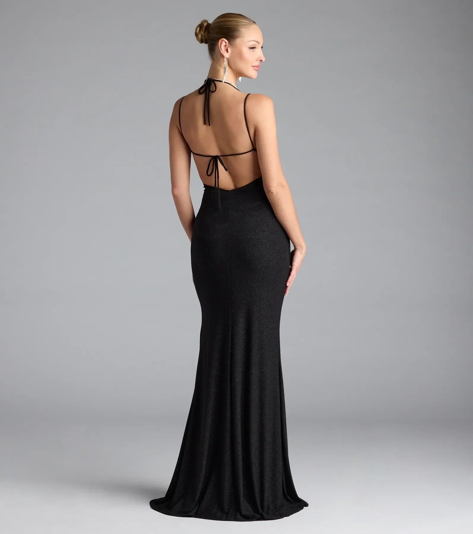 Turn heads at Prom 2025 in this black prom dress, where statement-making details meet the iconic style of the Ariadna Strappy Open Back Slit Glitter Formal Dress.