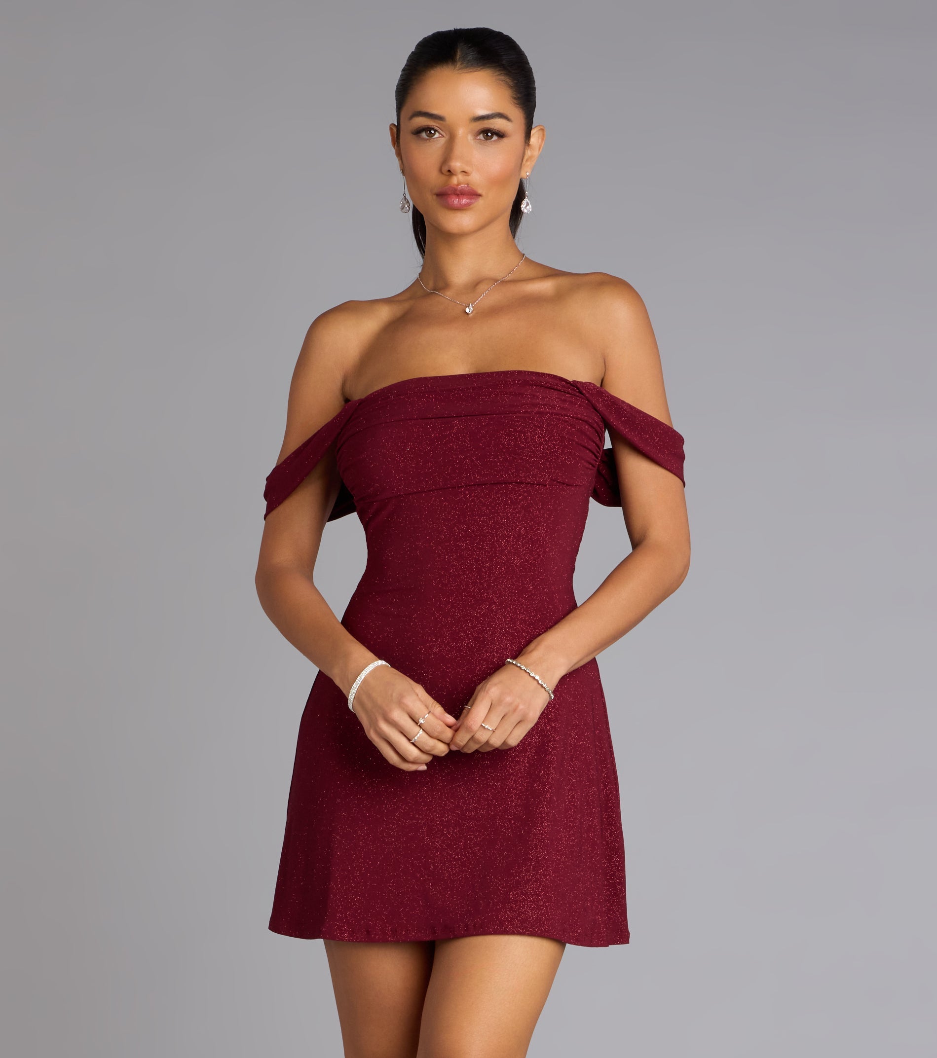 The Classic Glitz Glitter Knit Off-The-Shoulder Mini Dress is your new go-to Windsor dress—effortless, versatile, and made to update your fall style in seconds.