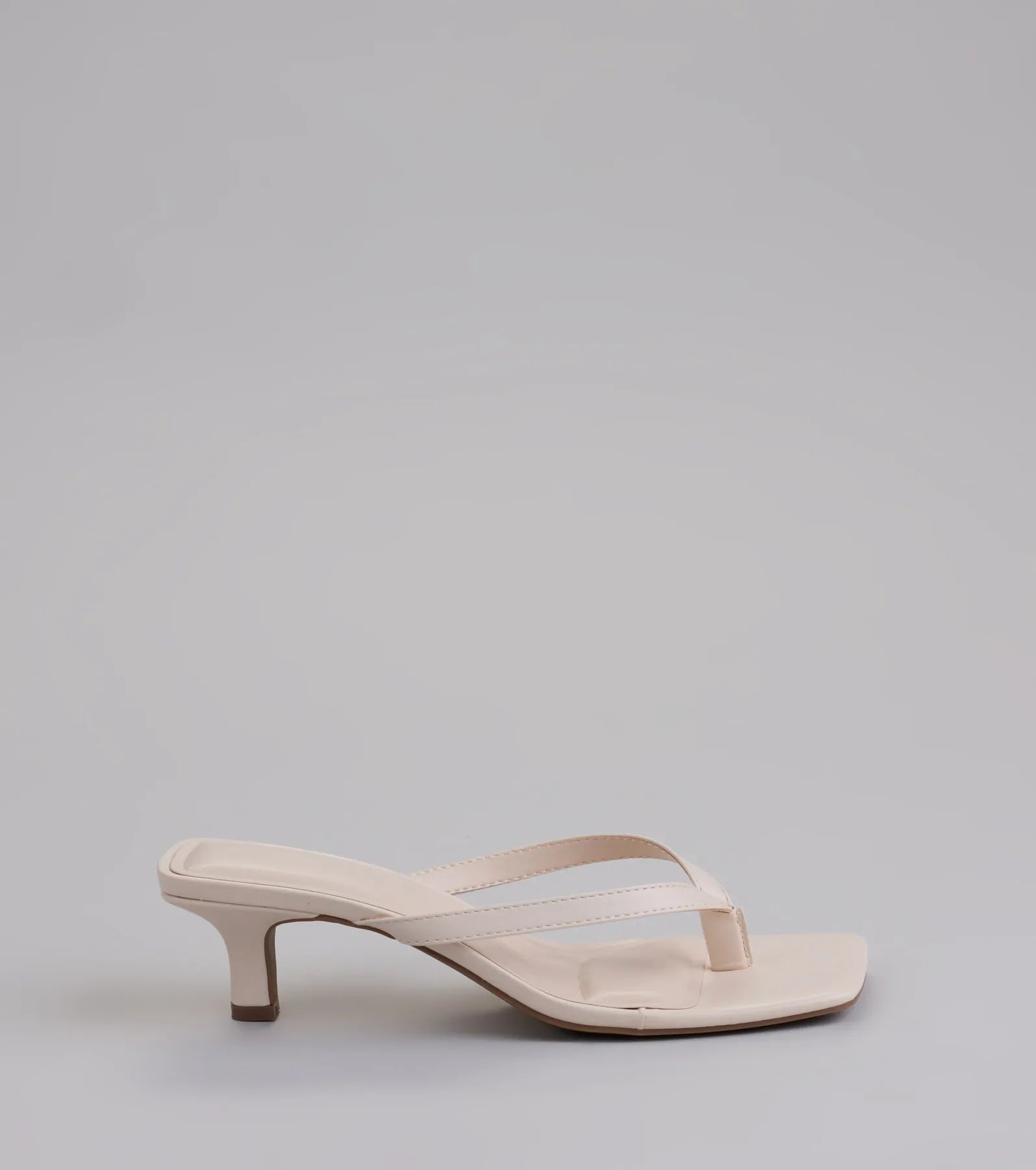 Elevate warm-weather looks with Feeling Chic Thong Square Toe Heels in ivory, a pair of trendy sandals bringing chic, modern flair to every step.