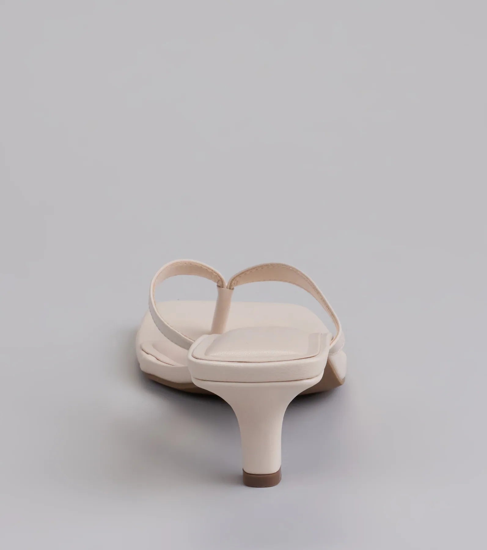 Elevate warm-weather looks with Feeling Chic Thong Square Toe Heels in ivory, a pair of trendy sandals bringing chic, modern flair to every step.