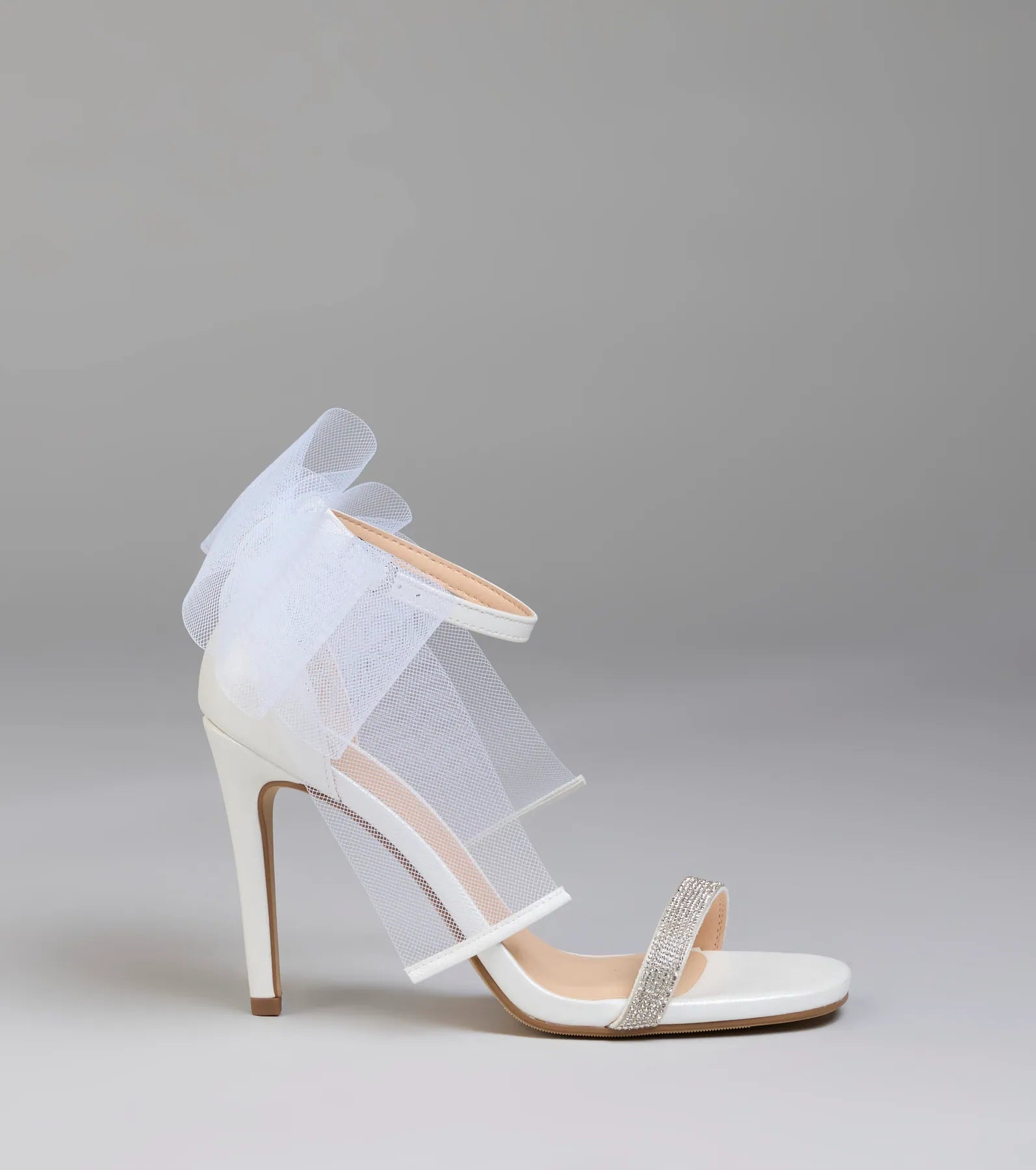 Elevate warm-weather looks with Tied With A Bow Stiletto Heels in white, a pair of trendy sandals bringing chic, modern flair to every step.