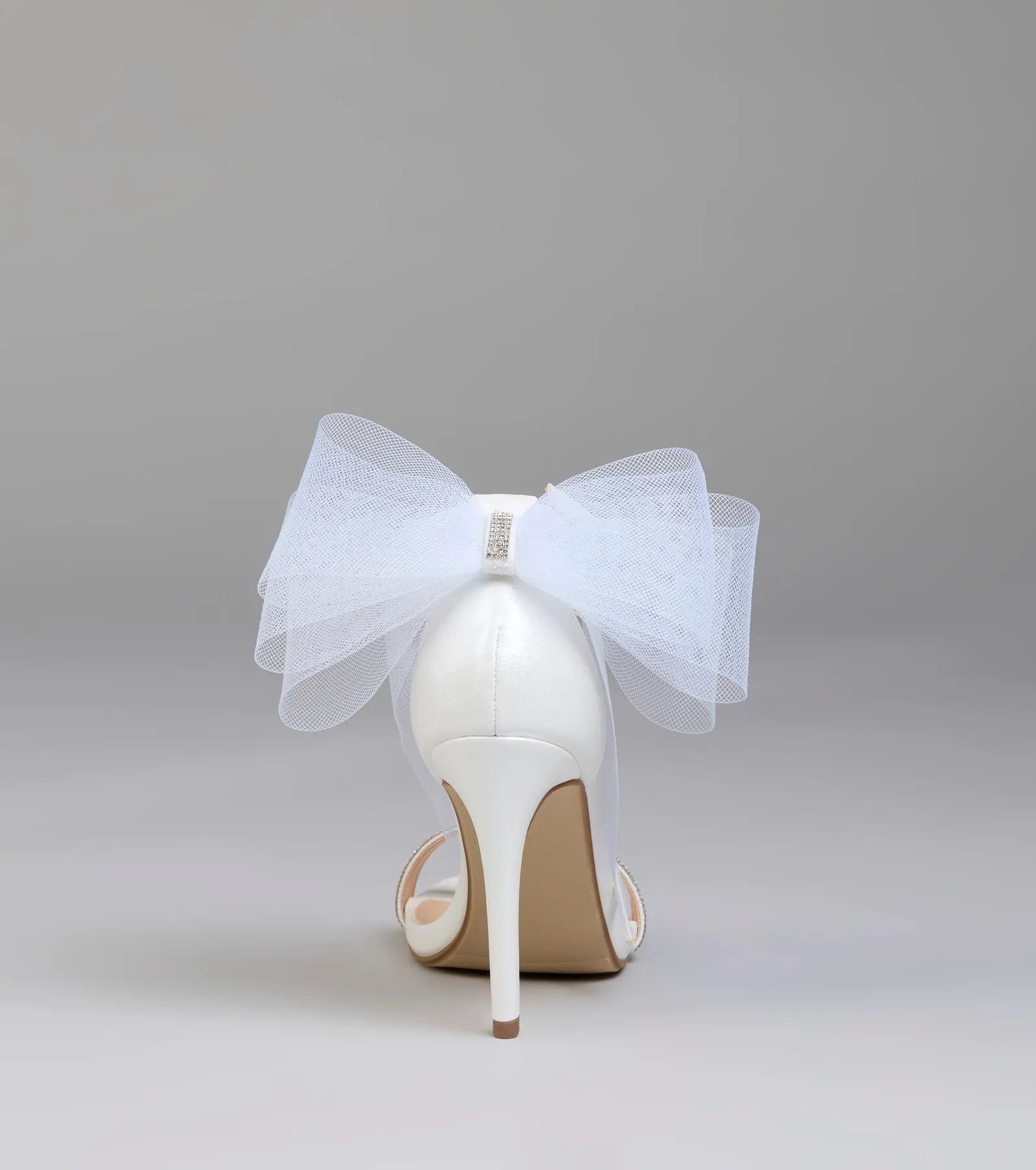 Elevate warm-weather looks with Tied With A Bow Stiletto Heels in white, a pair of trendy sandals bringing chic, modern flair to every step.