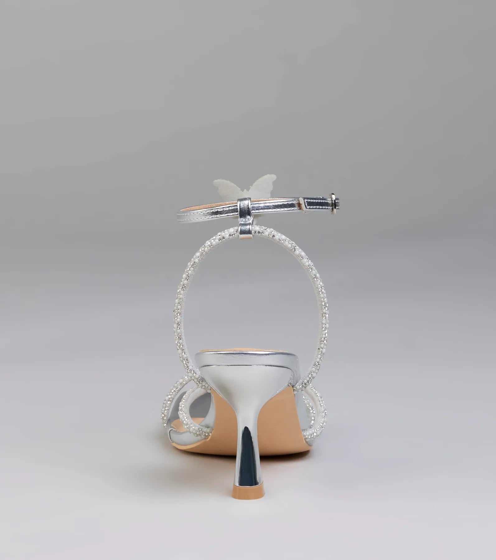 Elevate warm-weather looks with Fab Icon Butterfly Rhinestone Stiletto Heels in silver, a pair of trendy sandals bringing chic, modern flair to every step.