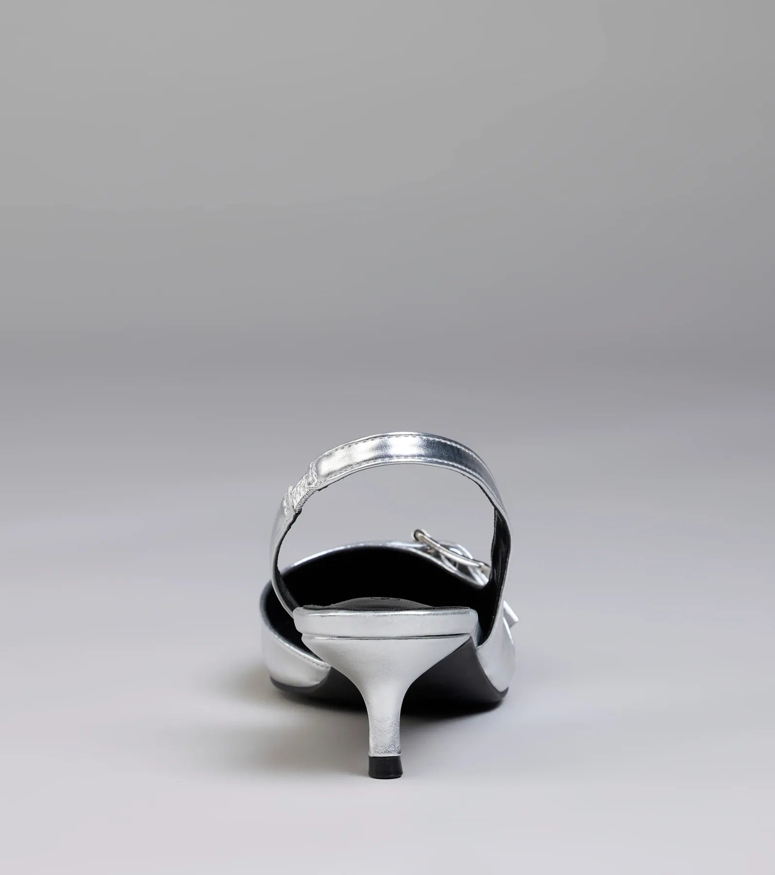 Turn heads in the Sleek Trendy Buckle Strap Slingback Kitten Heels, silver heels showcasing a fresh trend or stylish detail made to elevate your full Windsor fit.