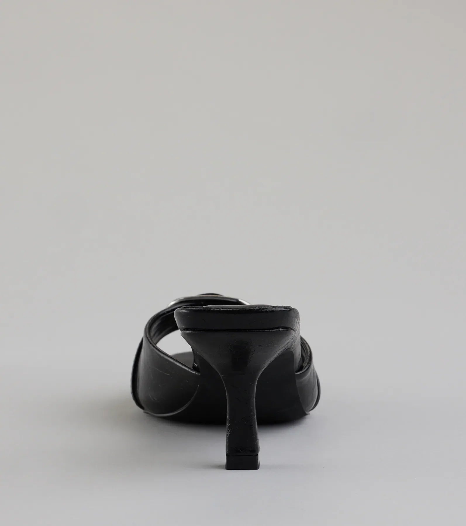 Elevate warm-weather looks with Brunch To Cocktails Buckle Stiletto Mules in black, a pair of trendy sandals bringing chic, modern flair to every step.