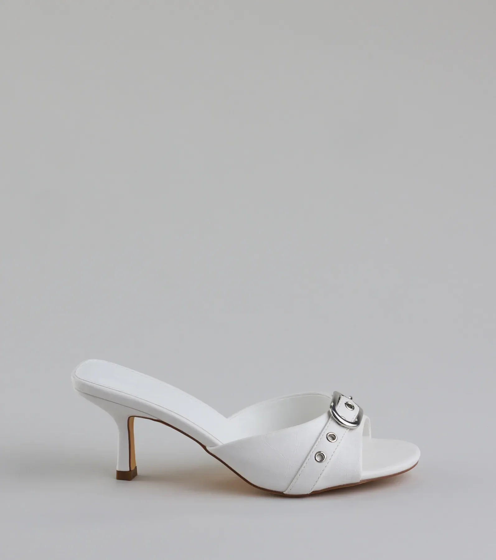 Elevate warm-weather looks with Brunch To Cocktails Buckle Stiletto Mules in white, a pair of trendy sandals bringing chic, modern flair to every step.