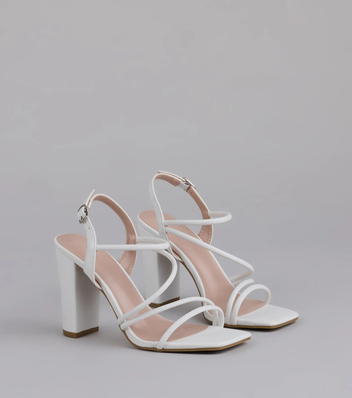 Style made simple with the Flirt Mode Activated Strappy Block Heels in white, trendy women’s shoes that take your outfit from basic to bold in one step.
