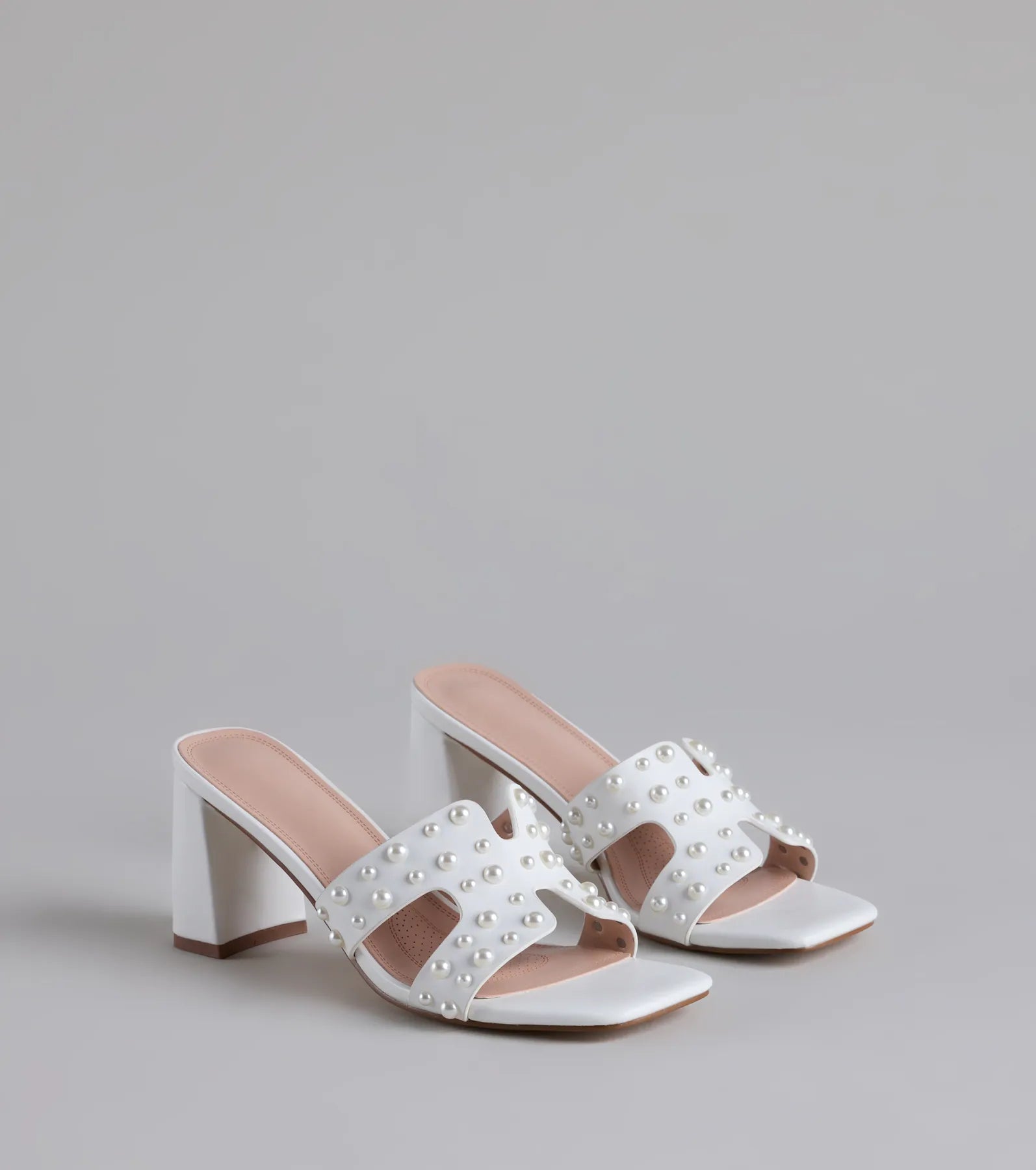 Style made simple with the Playful Poise Pearl Block Heel Mules in white, trendy women’s shoes that take your outfit from basic to bold in one step.