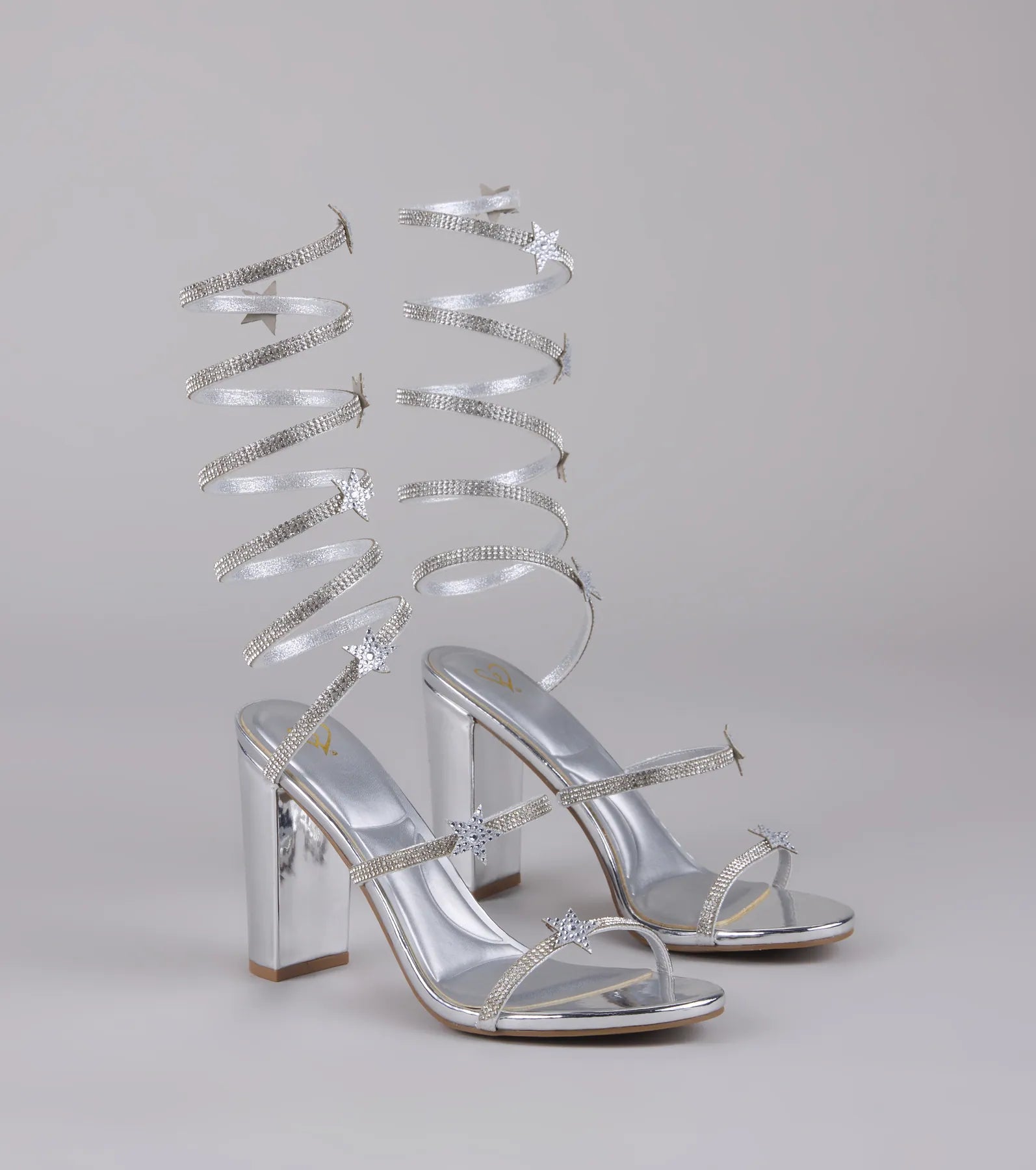 Style made simple with the Catch Me in the Cosmos Star Spiral Heels in silver, trendy women’s shoes that take your outfit from basic to bold in one step.