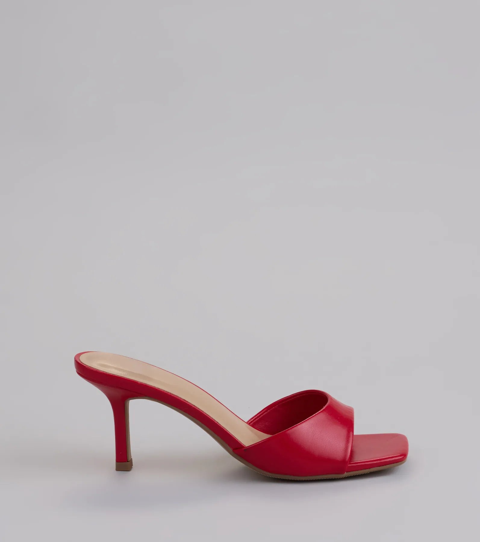 Elevate warm-weather looks with Glam Stunner Stiletto Mules in red, a pair of trendy sandals bringing chic, modern flair to every step.