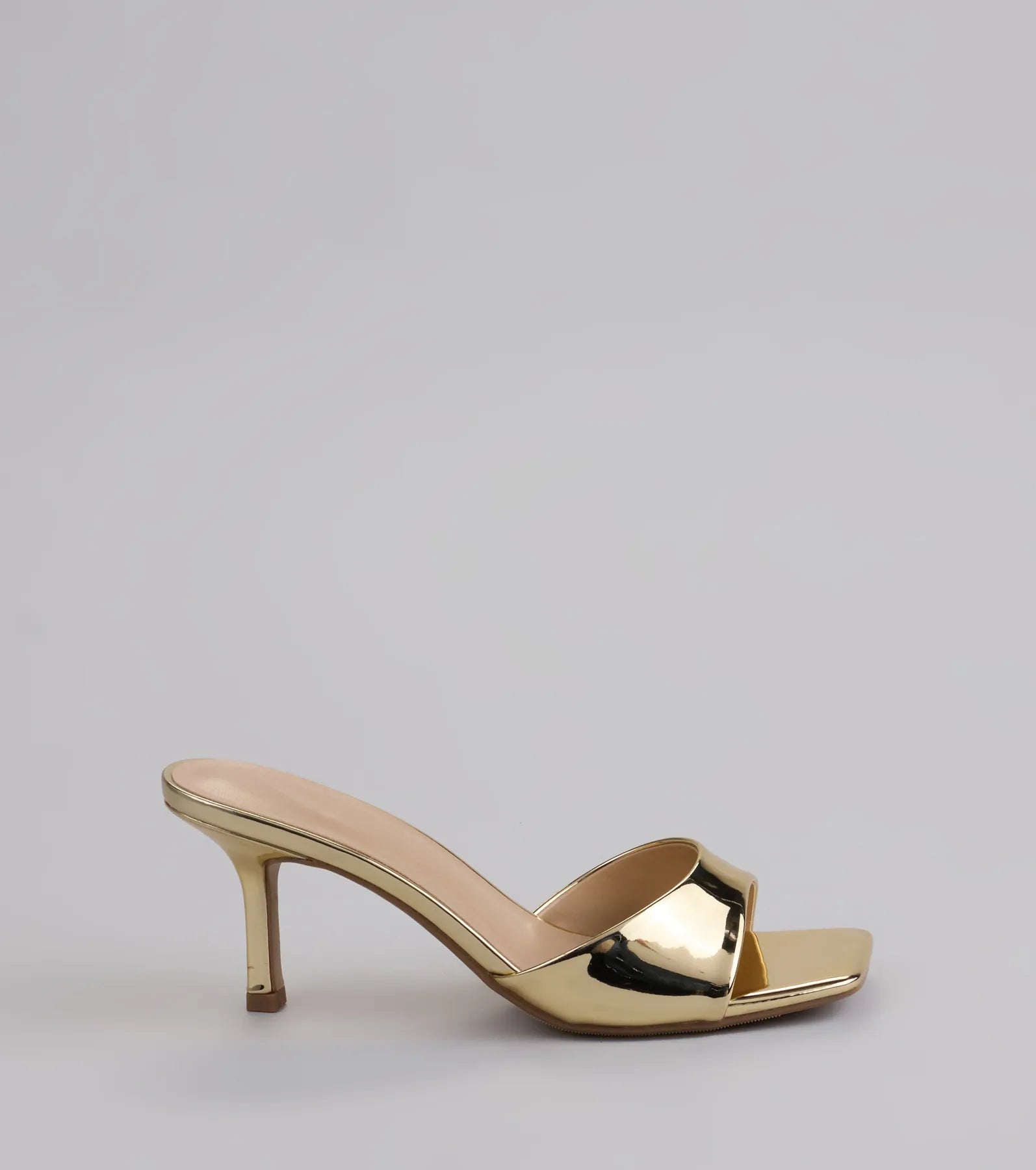 Elevate warm-weather looks with Glam Stunner Stiletto Mules in gold, a pair of trendy sandals bringing chic, modern flair to every step.