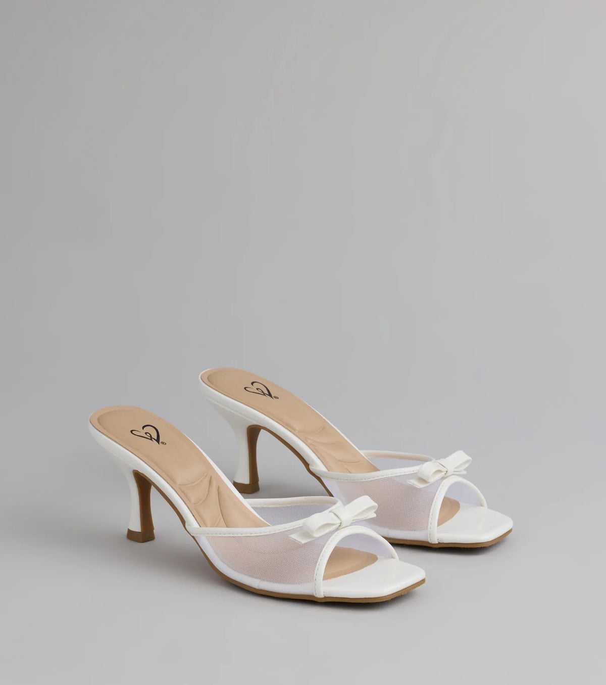 Style made simple with the Soft Glam Mesh Bow Mules in white, trendy women’s shoes that take your outfit from basic to bold in one step.
