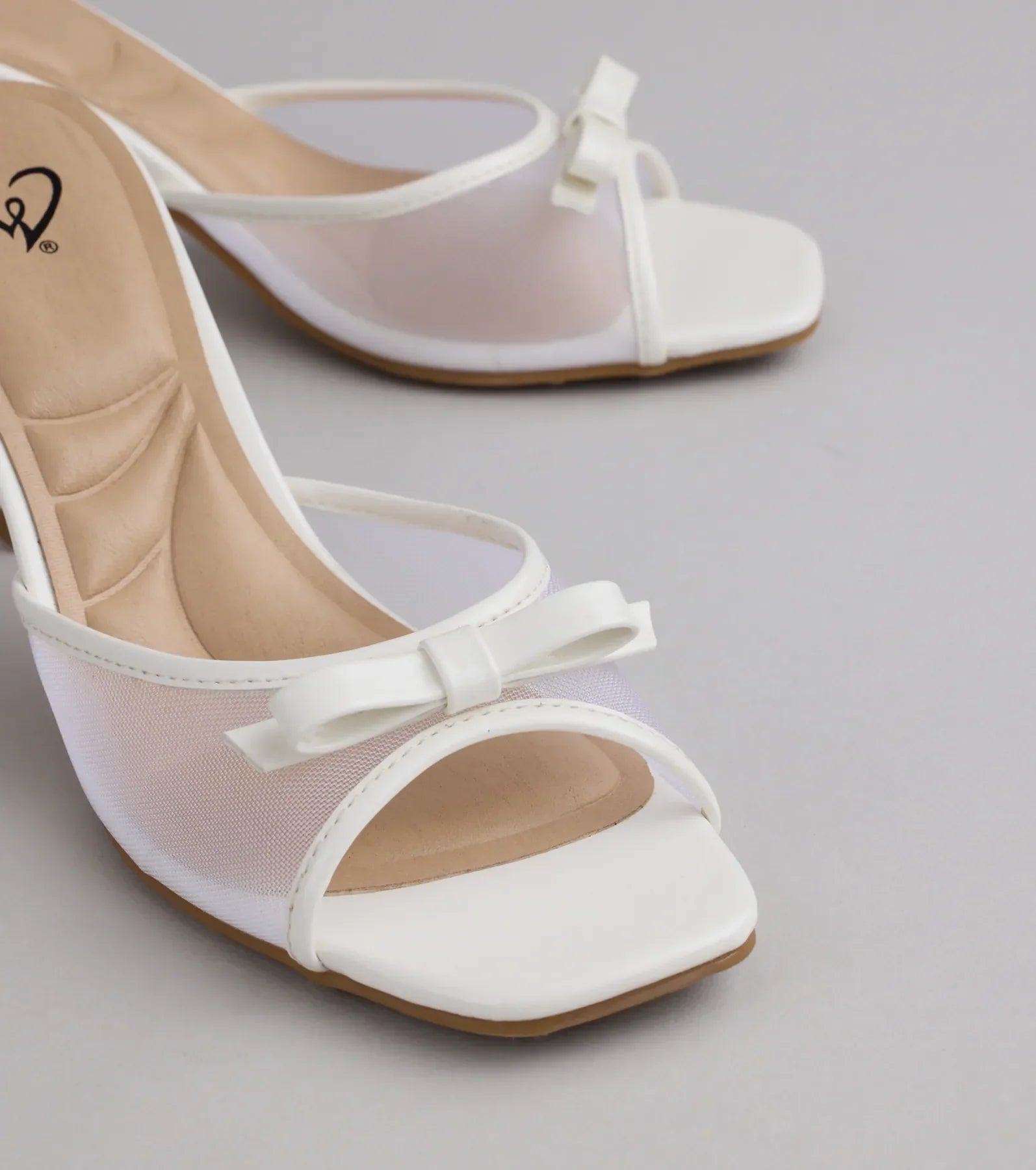 Style made simple with the Soft Glam Mesh Bow Mules in white, trendy women’s shoes that take your outfit from basic to bold in one step.