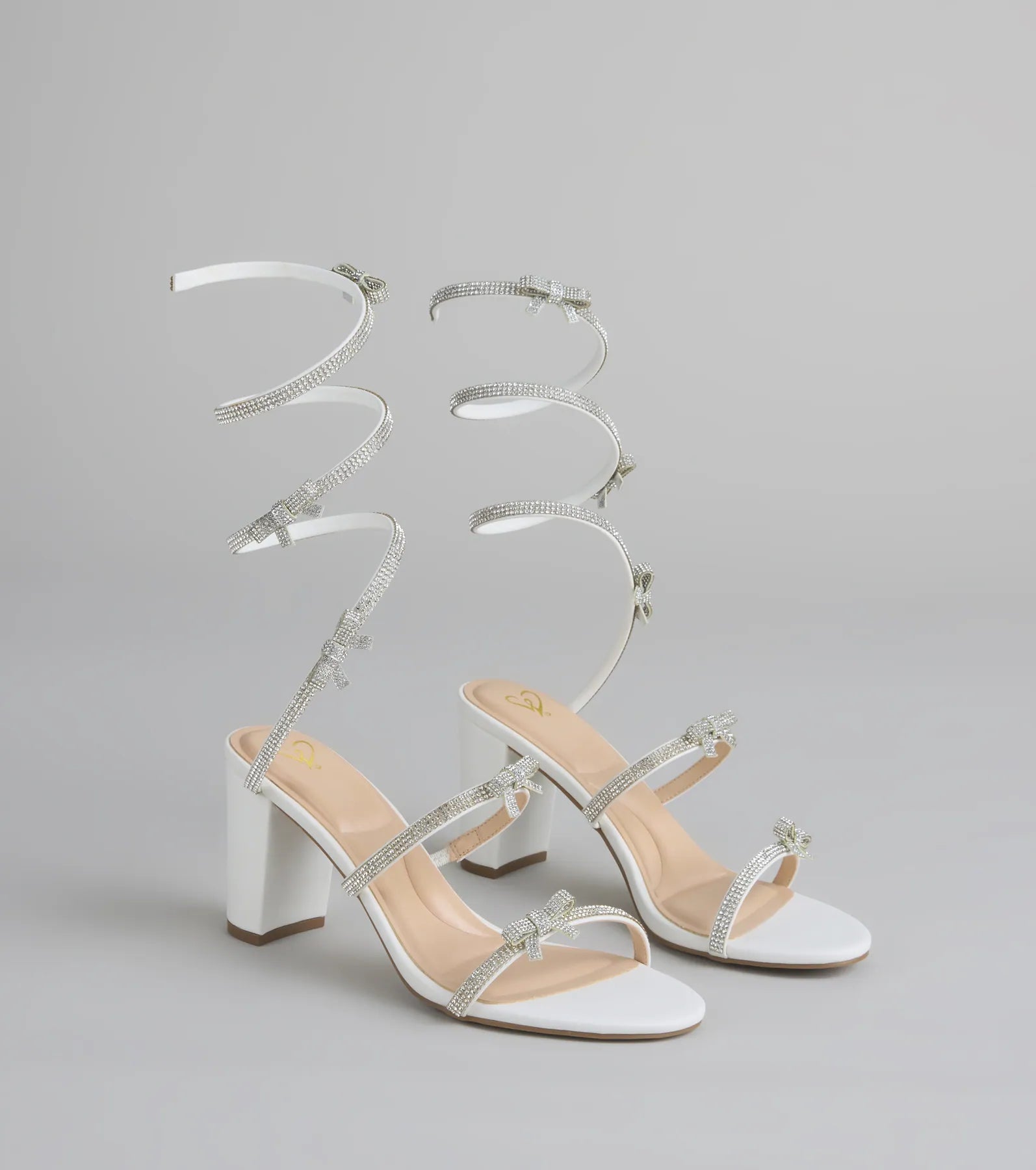Style made simple with the Put A Bow On It Rhinestone Bow Spiral Heels in white, trendy women’s shoes that take your outfit from basic to bold in one step.