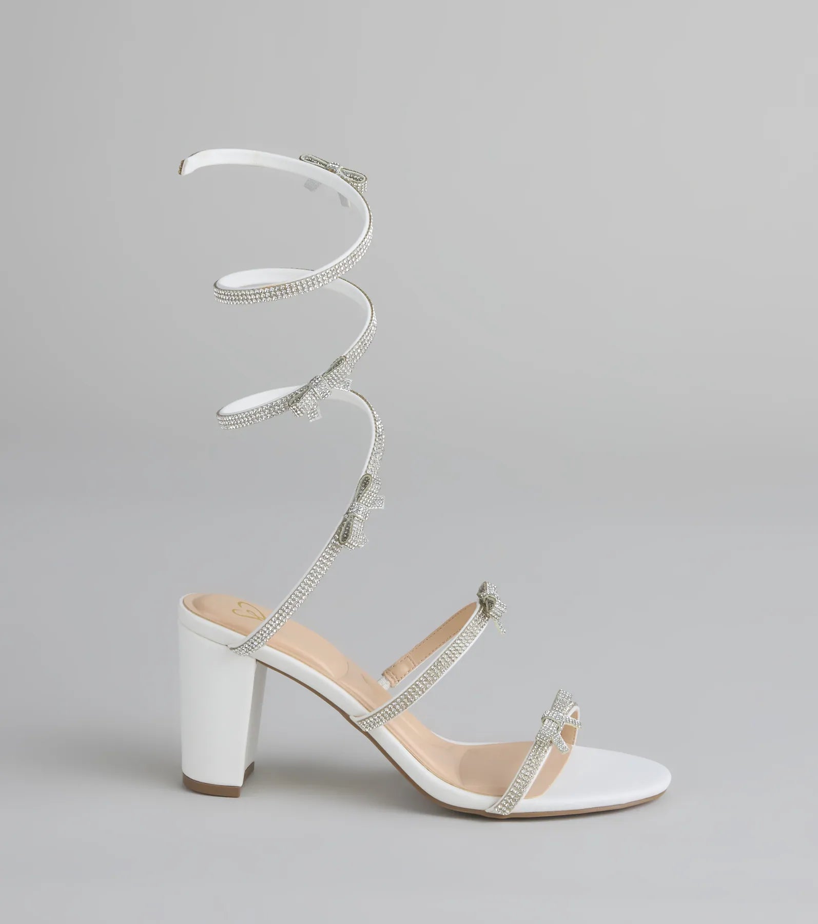Style made simple with the Put A Bow On It Rhinestone Bow Spiral Heels in white, trendy women’s shoes that take your outfit from basic to bold in one step.