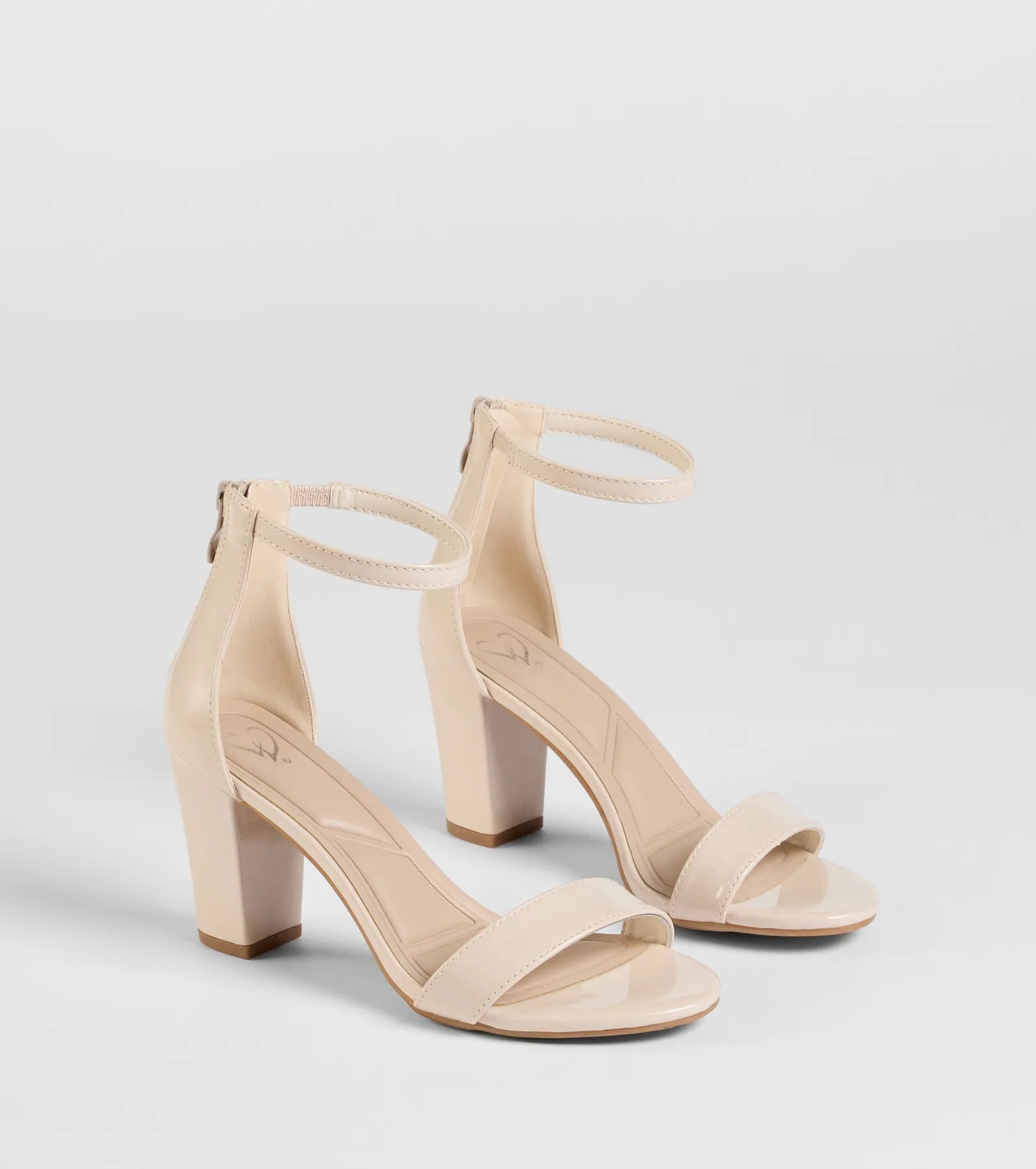 Style made simple with the Smooth And Sleek Block Heels in ivory, trendy women’s shoes that take your outfit from basic to bold in one step.