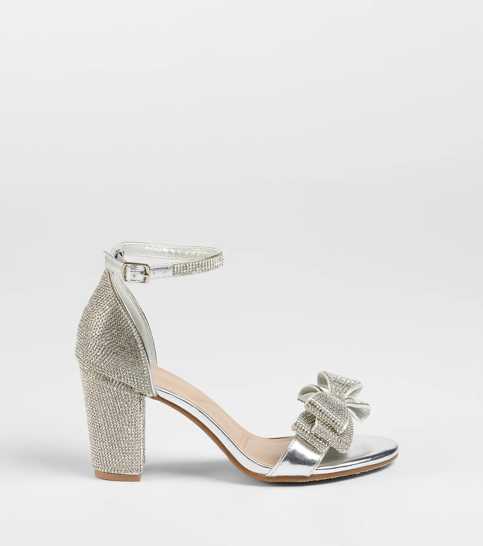Turn heads in the Endless Glam Rhinestone Bow Block Heels, silver heels showcasing a fresh trend or stylish detail made to elevate your full Windsor fit.